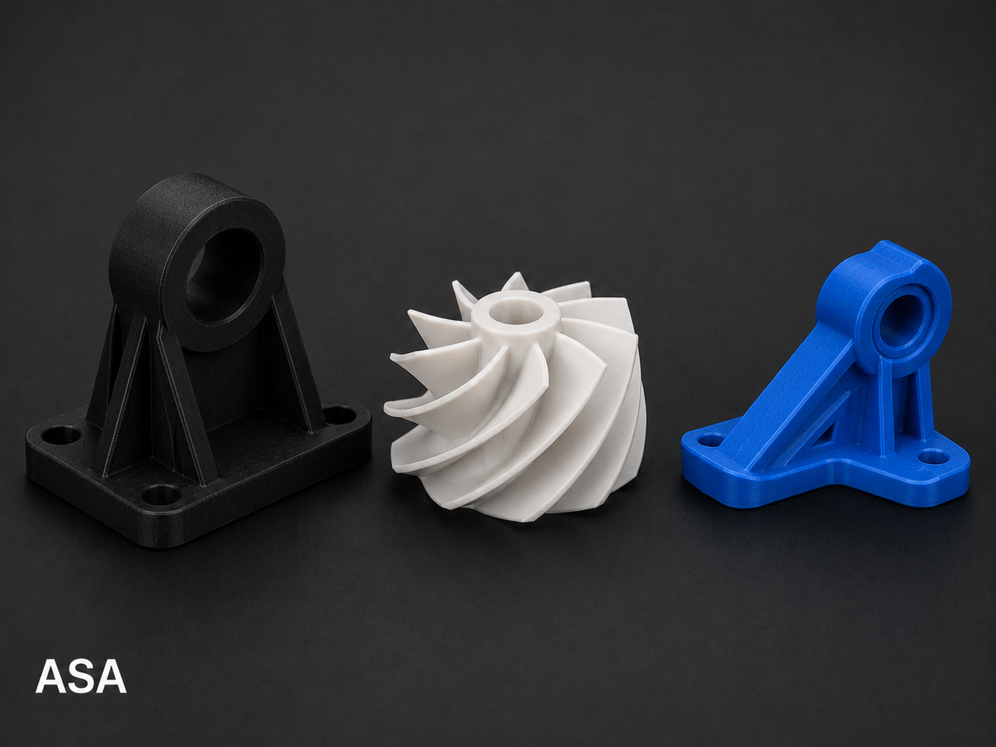 Three 3D-printed turbocharger impellers and housings, black and blue in color, displayed on a dark background, with the text 'ASA' in the bottom left corner.