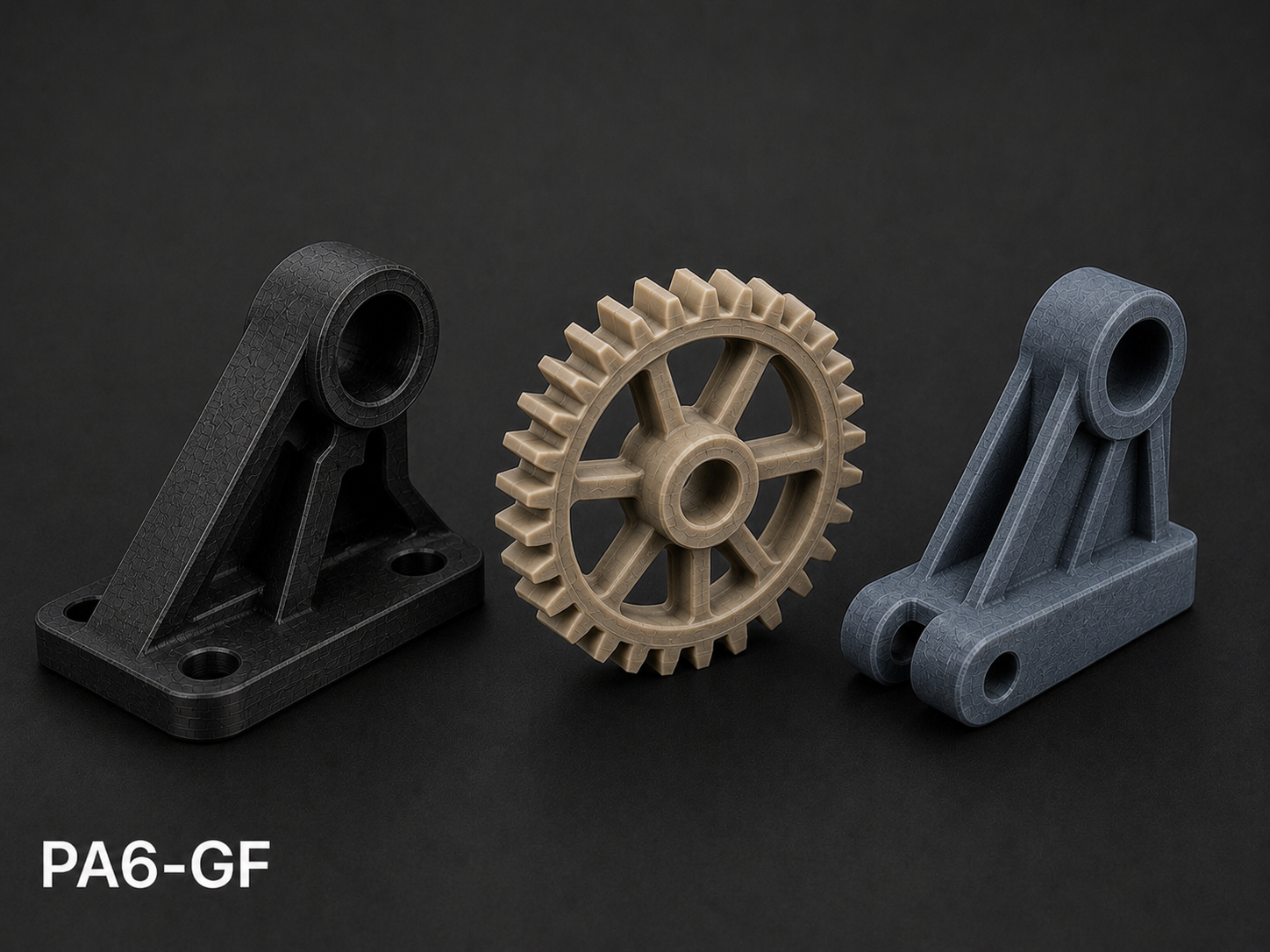 Three industrial 3D-printed plastic mechanical parts on a black background, with a label 'PA6-GF' in the lower left corner.