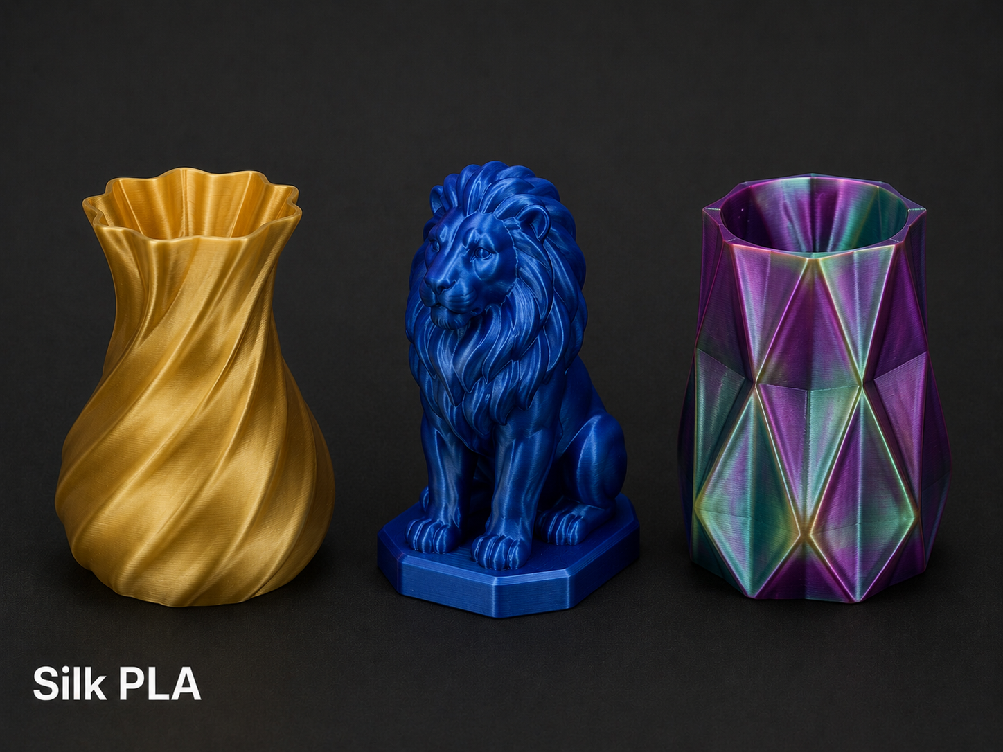 Three decorative vases, from left to right: a gold-colored vase with a twisting, wavy design, a blue lion sculpture serving as a vase with a detailed mane, and a multicolored vase with geometric facets.