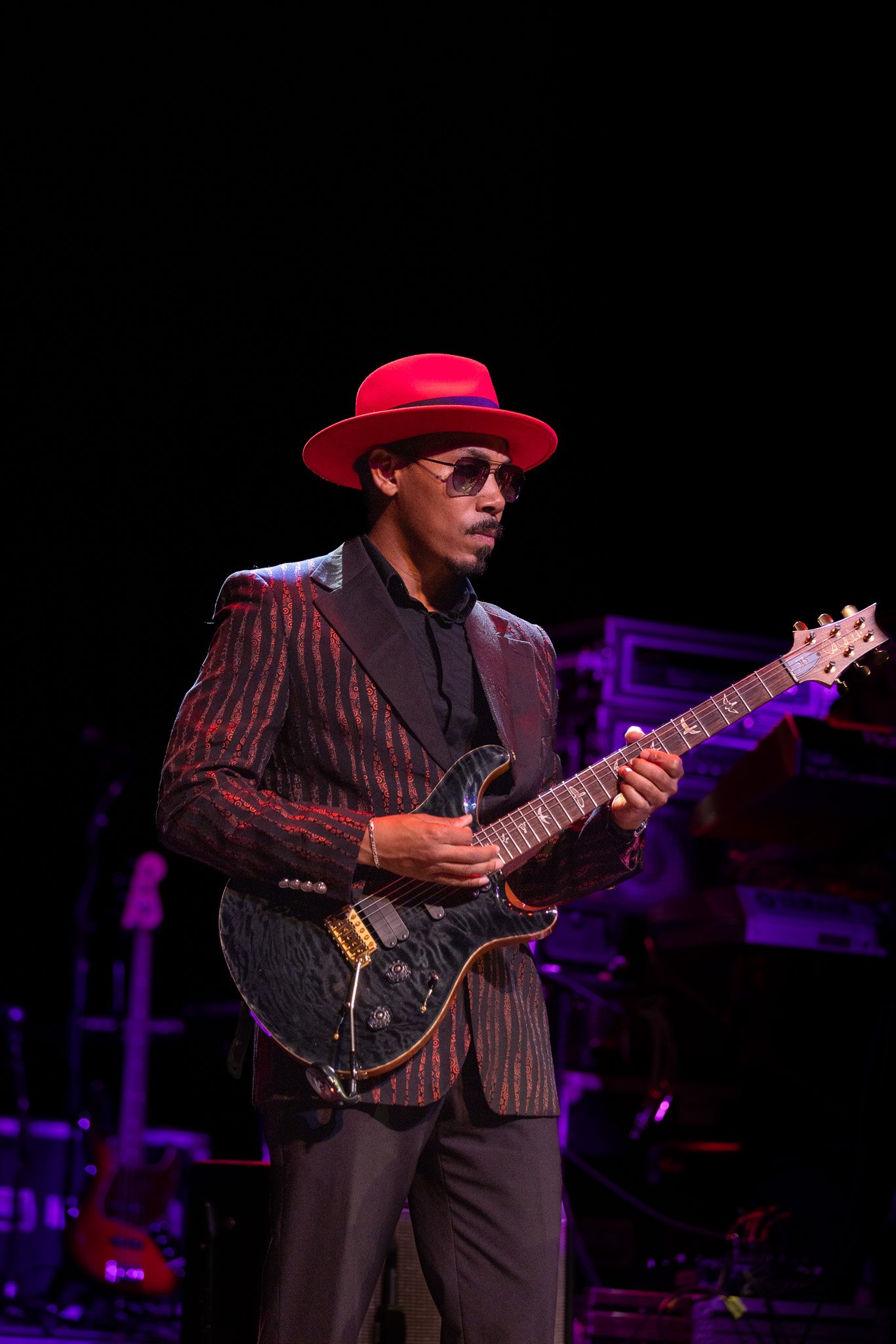 Guitarist from SOS Band performing live under stage lights at Clowes Memorial Hall on September 25, 2026.