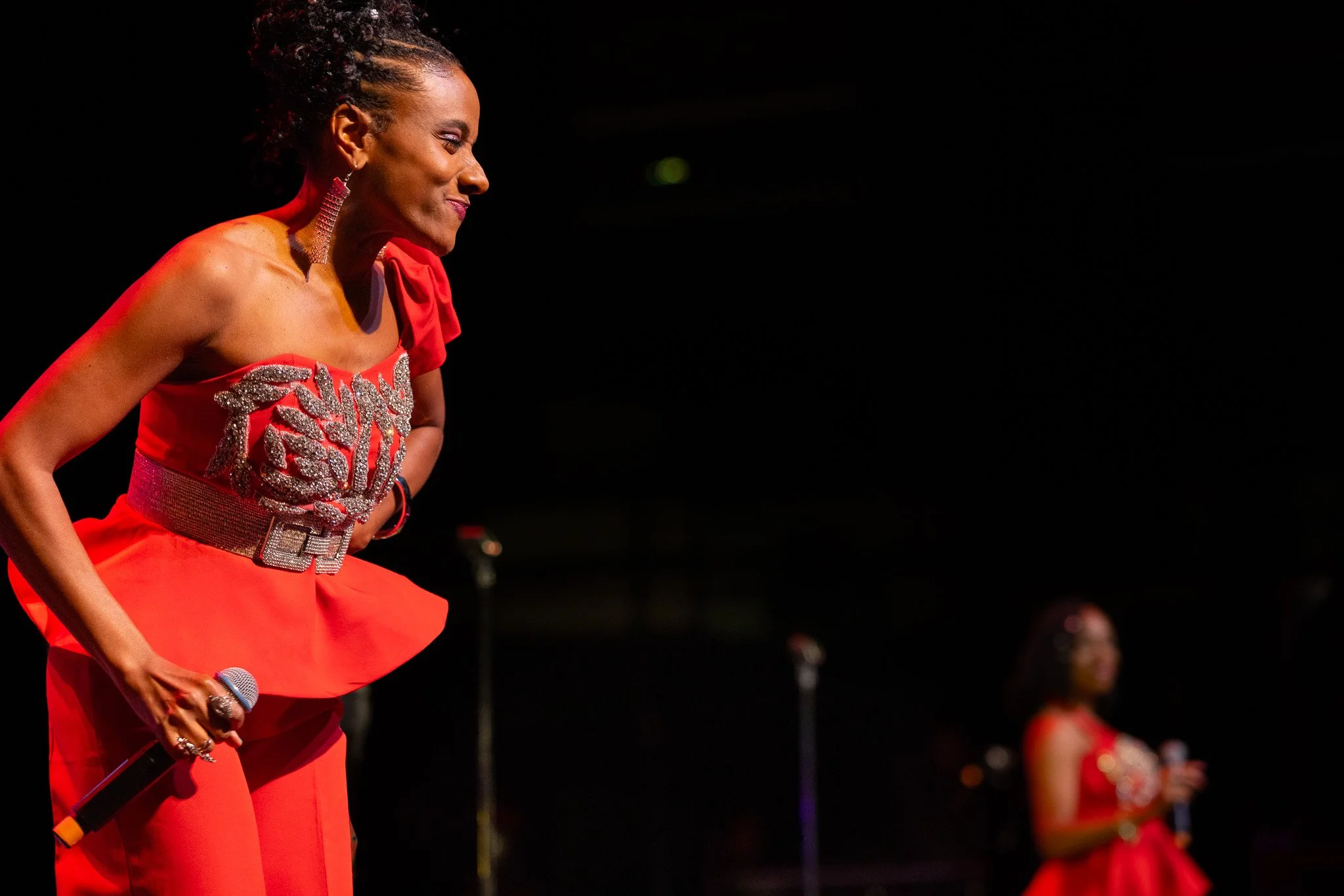 Marleen Thimas of SOS Band singing onstage with warm lighting at Clowes Memorial Hall during the 2026 performance.