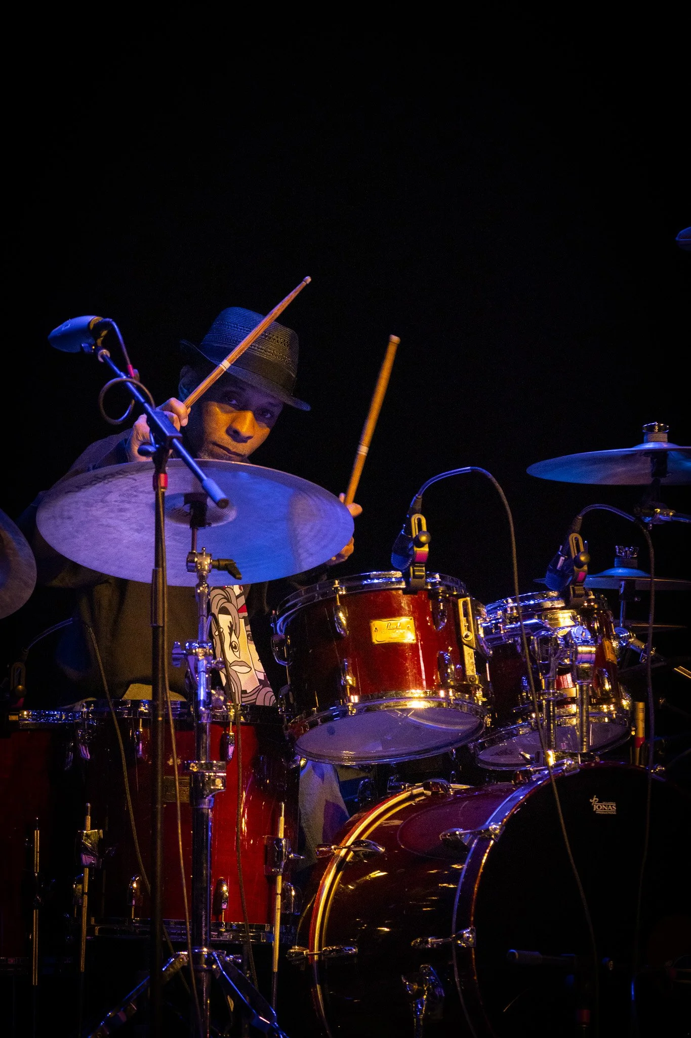 Drummer for Morris Day and The Time performing under stage lights at Clowes Memorial Hall.