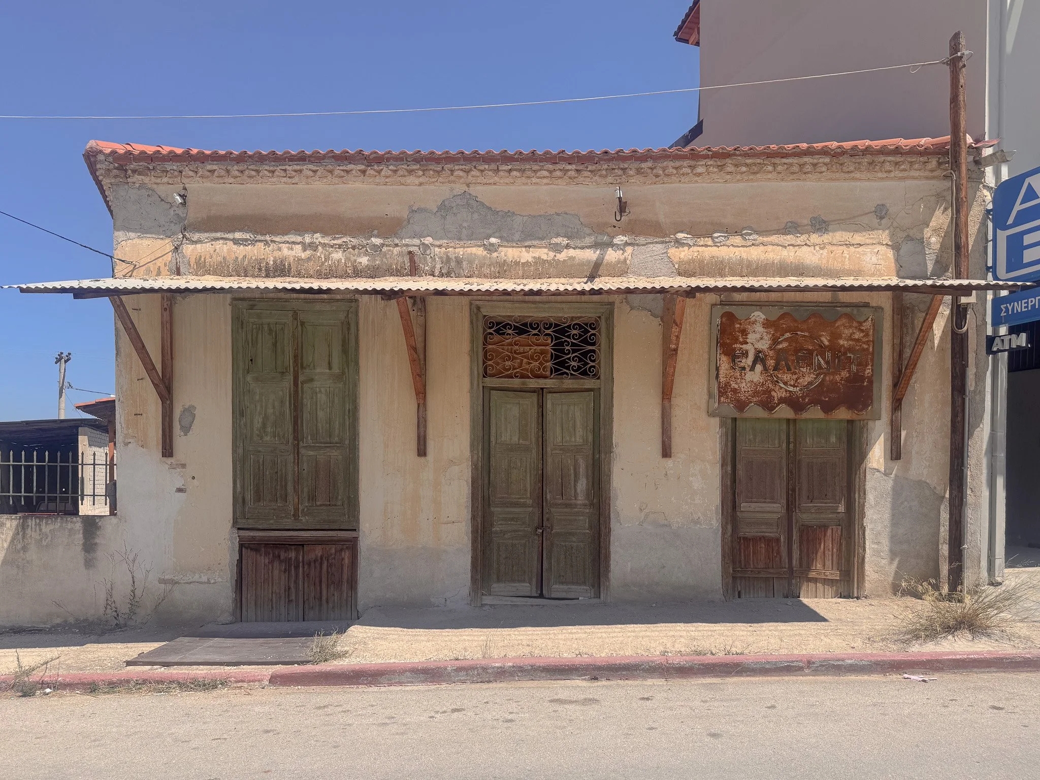 Neo‑classical building in Nemea with peeling paint.