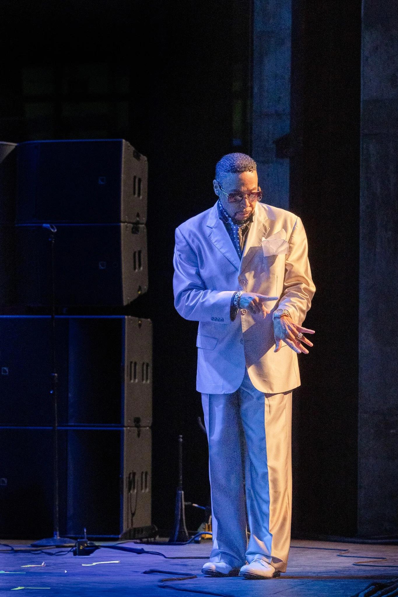Morris Day checking his signature watch mid‑performance at Clowes Memorial Hall.