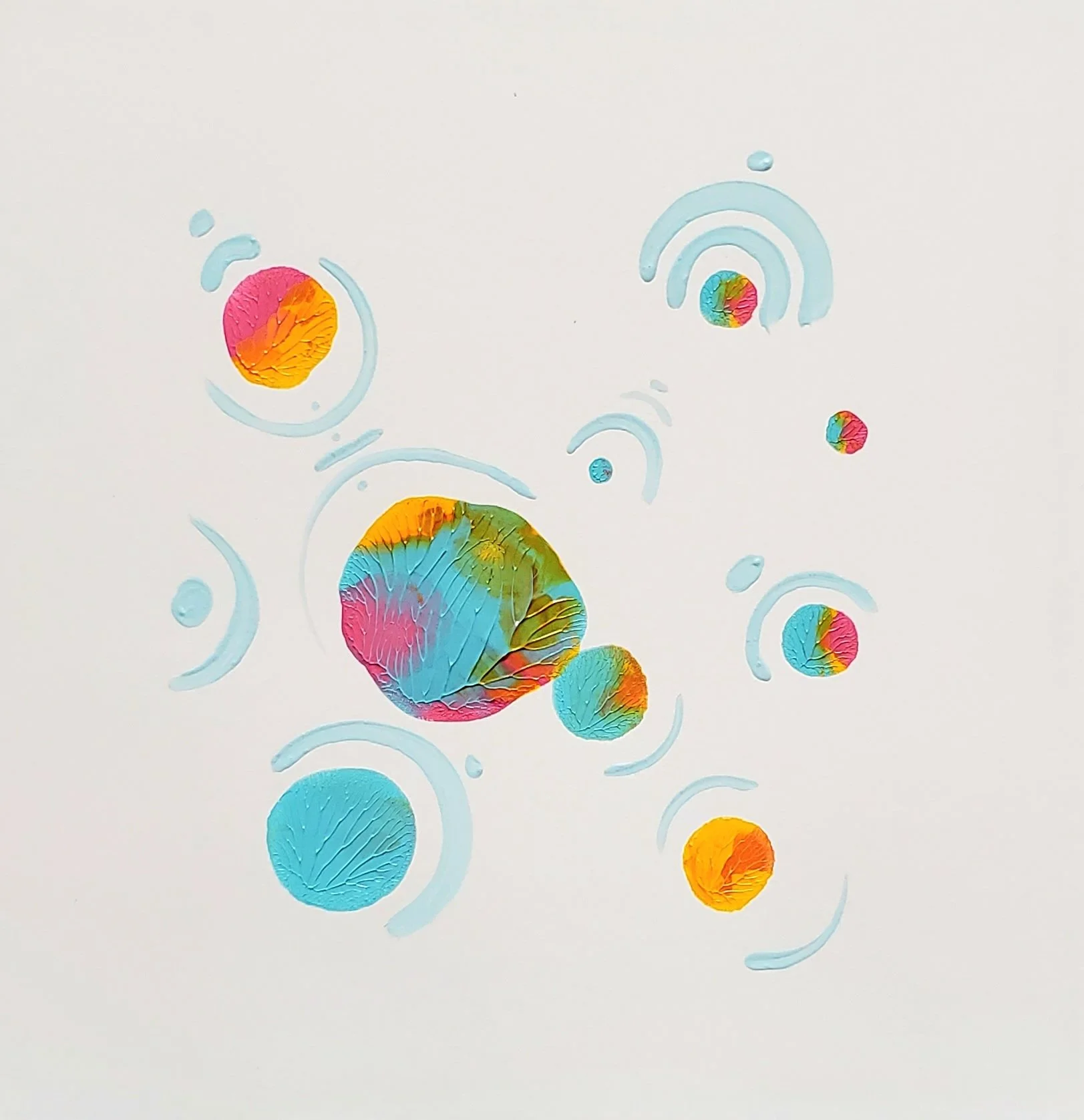 Colorful abstract paper circles and swirls on a white background.