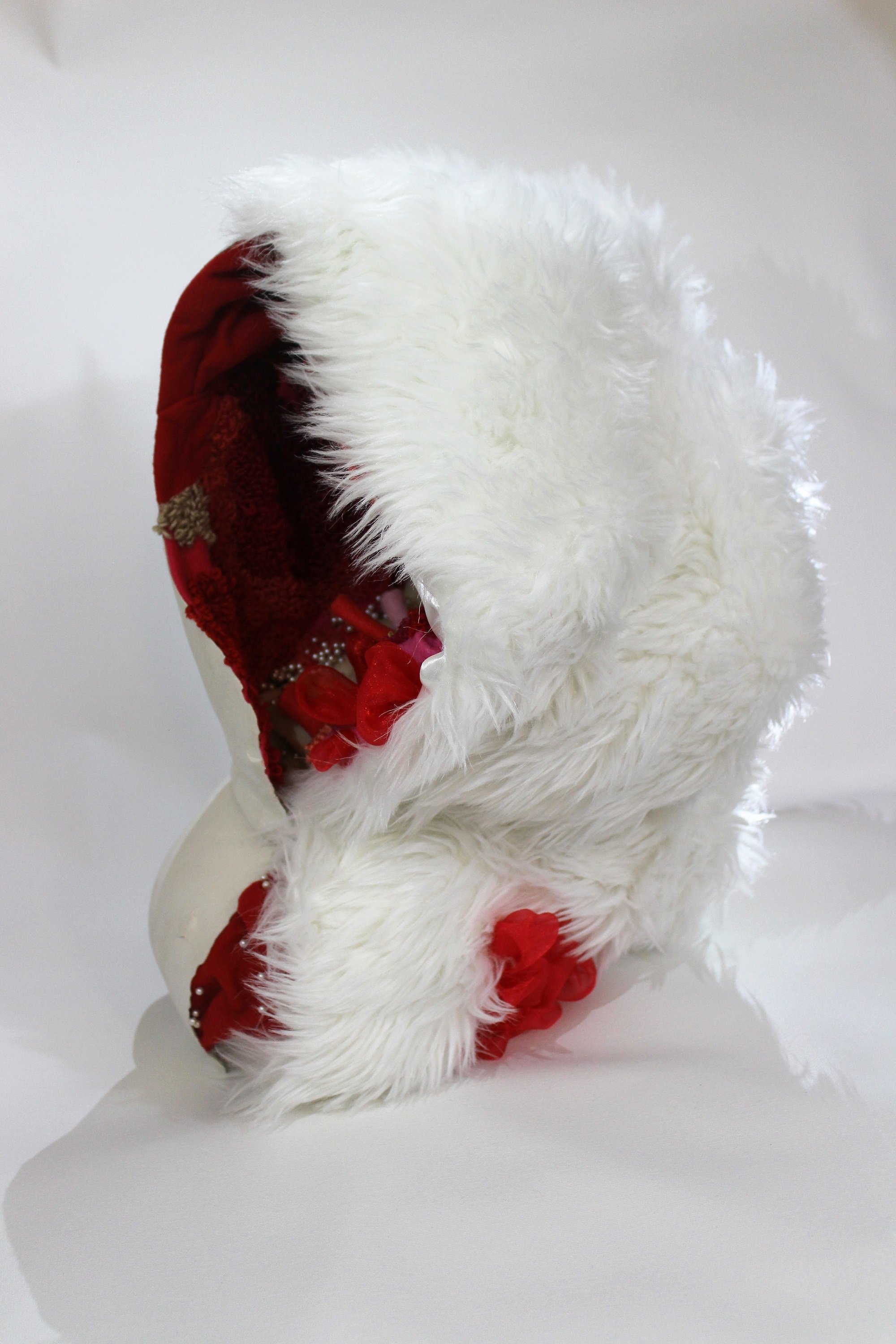 Close-up of a white torso showing a detailed interior filled with colorful fabric and decorative items.