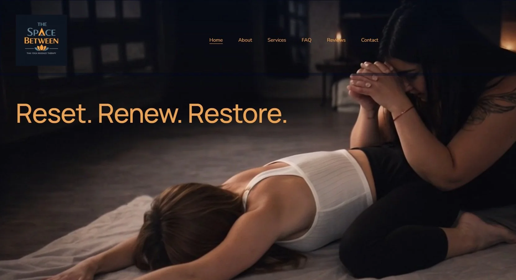 A woman lying face down on a yoga mat, receiving a Thai yoga massage from a therapist in a dark room. The text 'Reset. Renew. Restore.' is overlaid on the image.