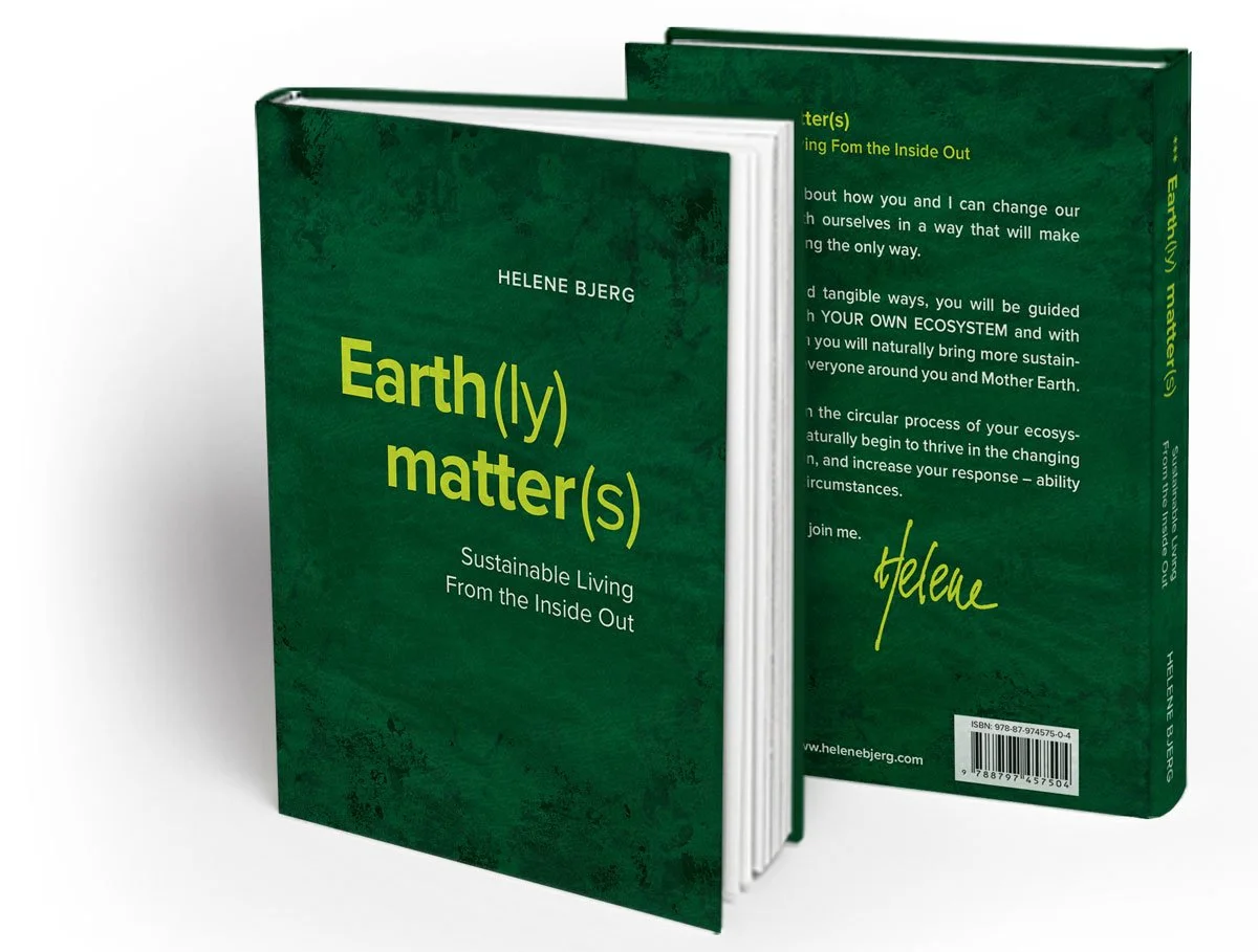 Book titled "Earth(l)y matter(s)" by Helene Bjerg, with subtitle "Sustainable Living From the Inside Out," placed upright with the back cover slightly visible showing the author's signature and website www.helenebjerg.com.