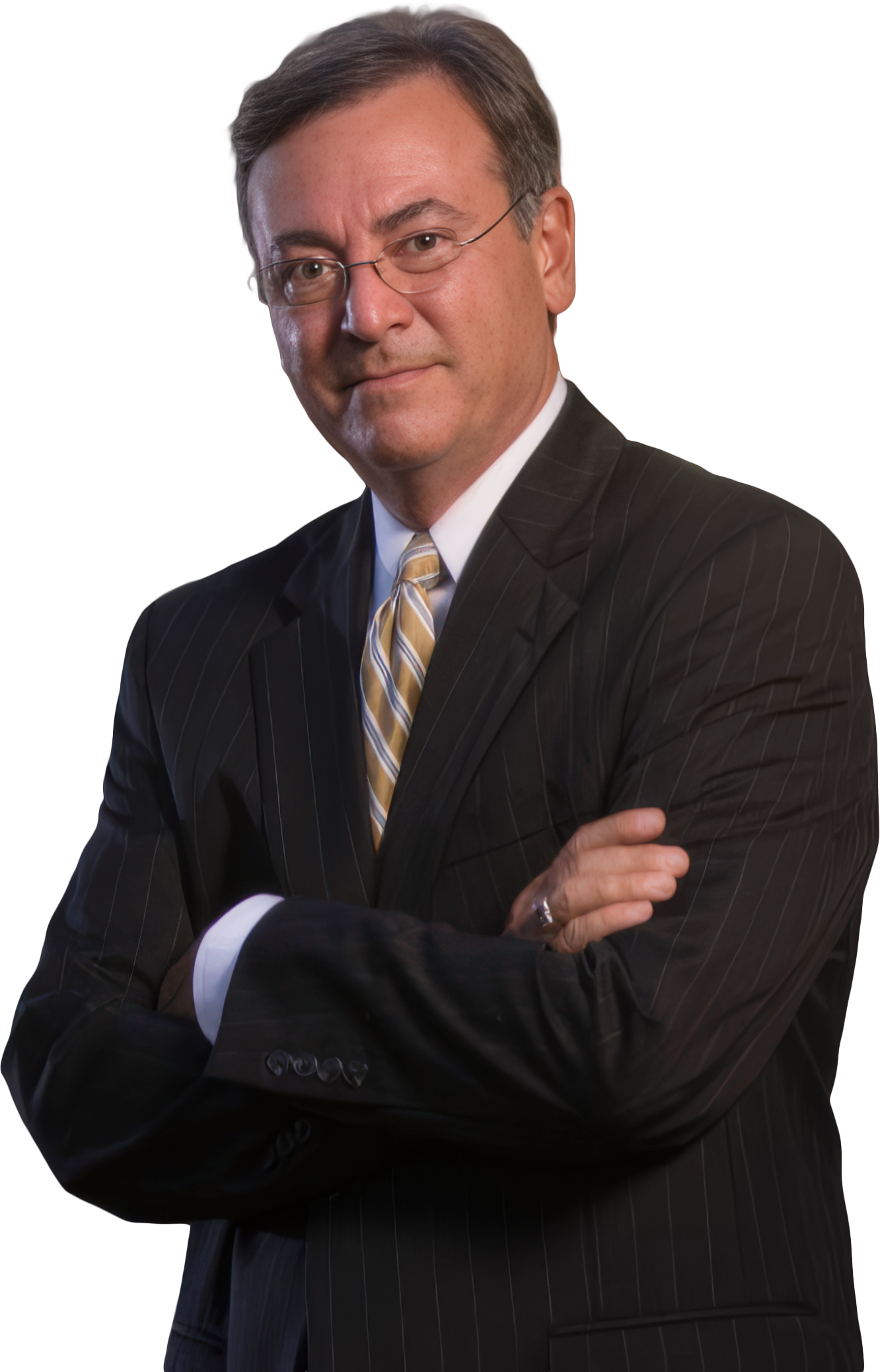 A man in a dark pinstripe suit with a white shirt and a yellow striped tie, wearing glasses, standing with arms crossed and looking at the camera.