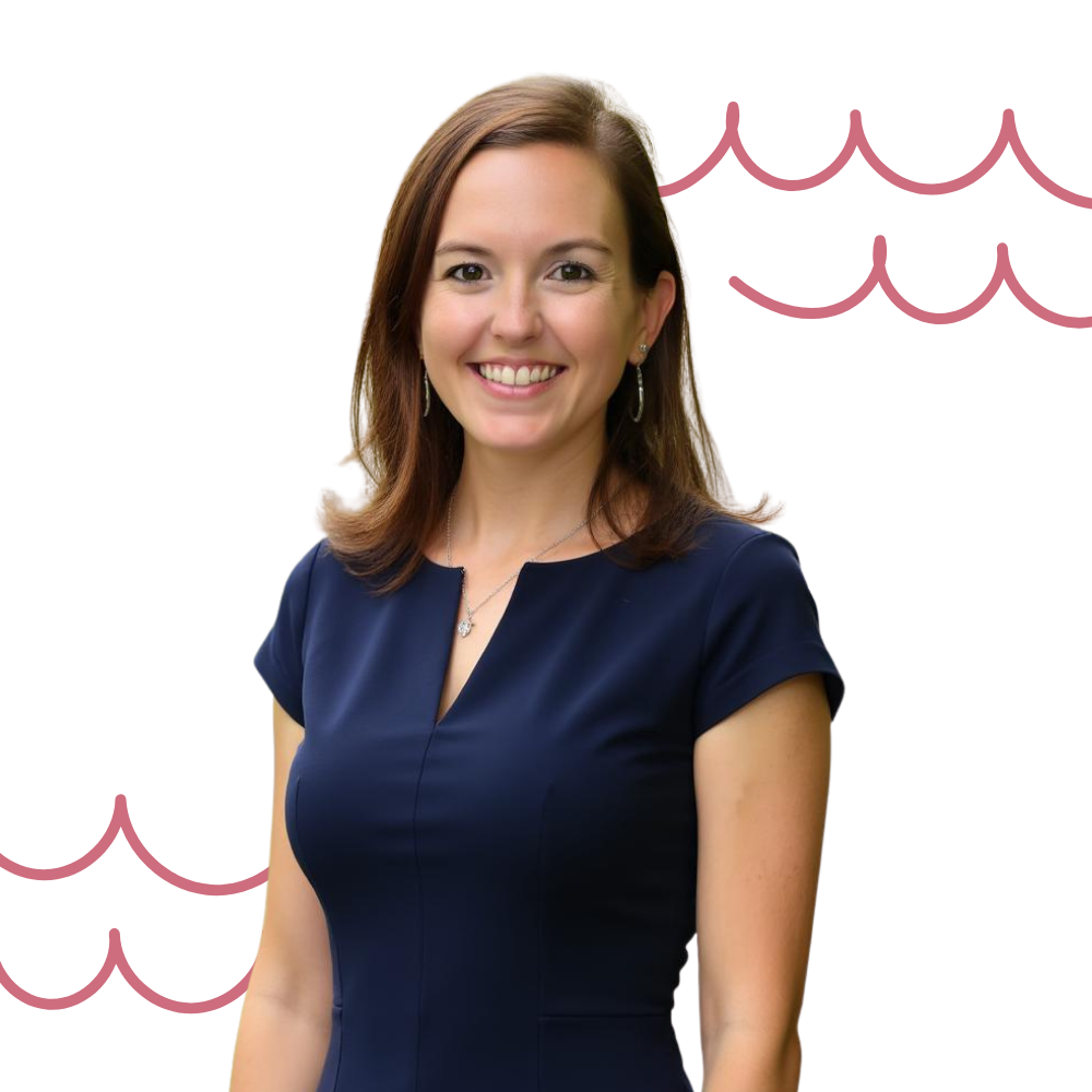 A woman with shoulder-length brown hair, wearing a navy blue dress, smiling in front of a background with pink wave patterns.
