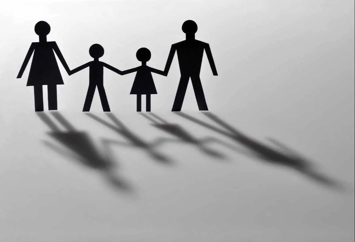 shadow image of two parents and two children holding hands