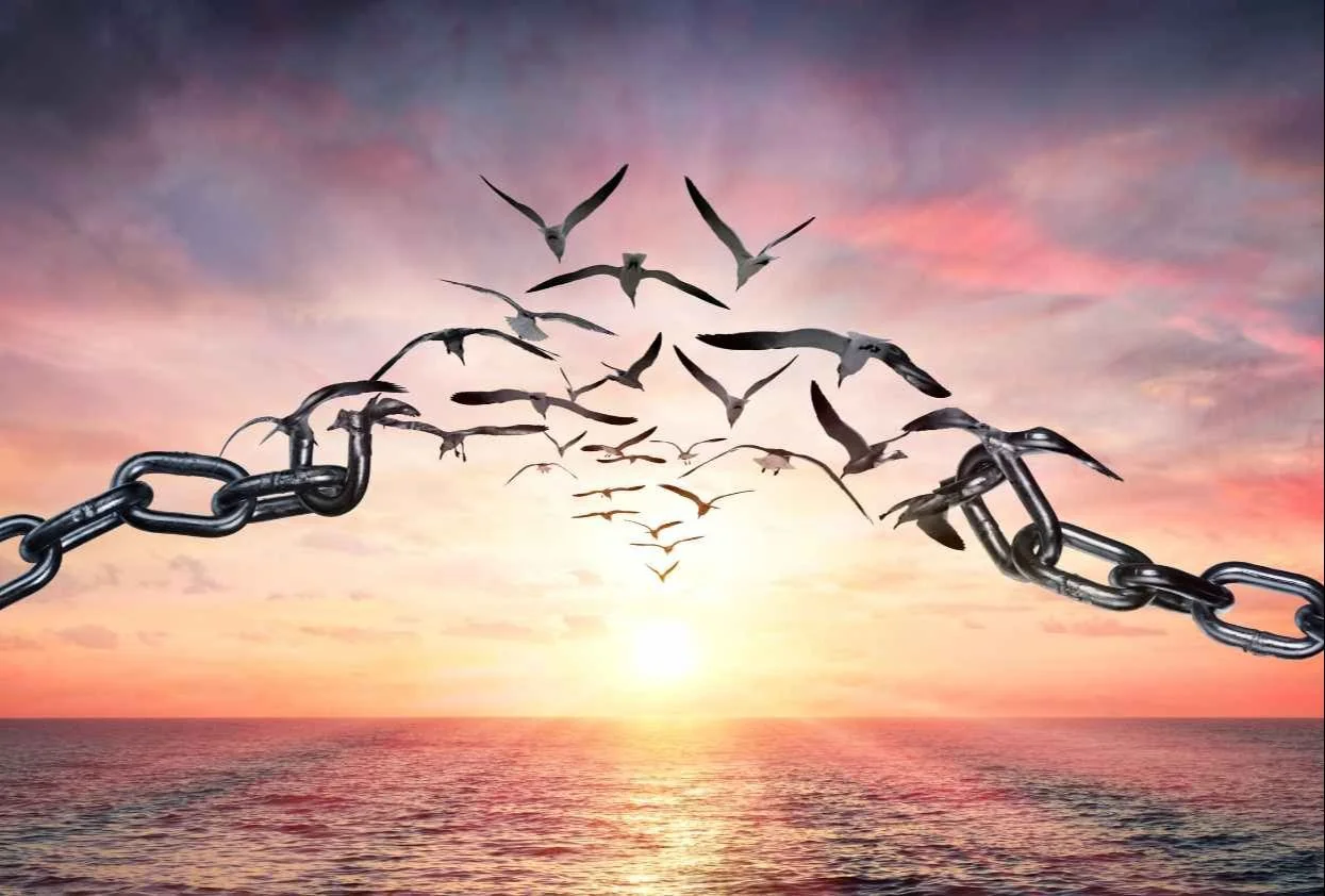 Chains breaking in sunrise of forgiveness