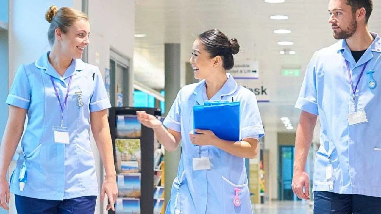 Three healthcare professionals talking in a hospital