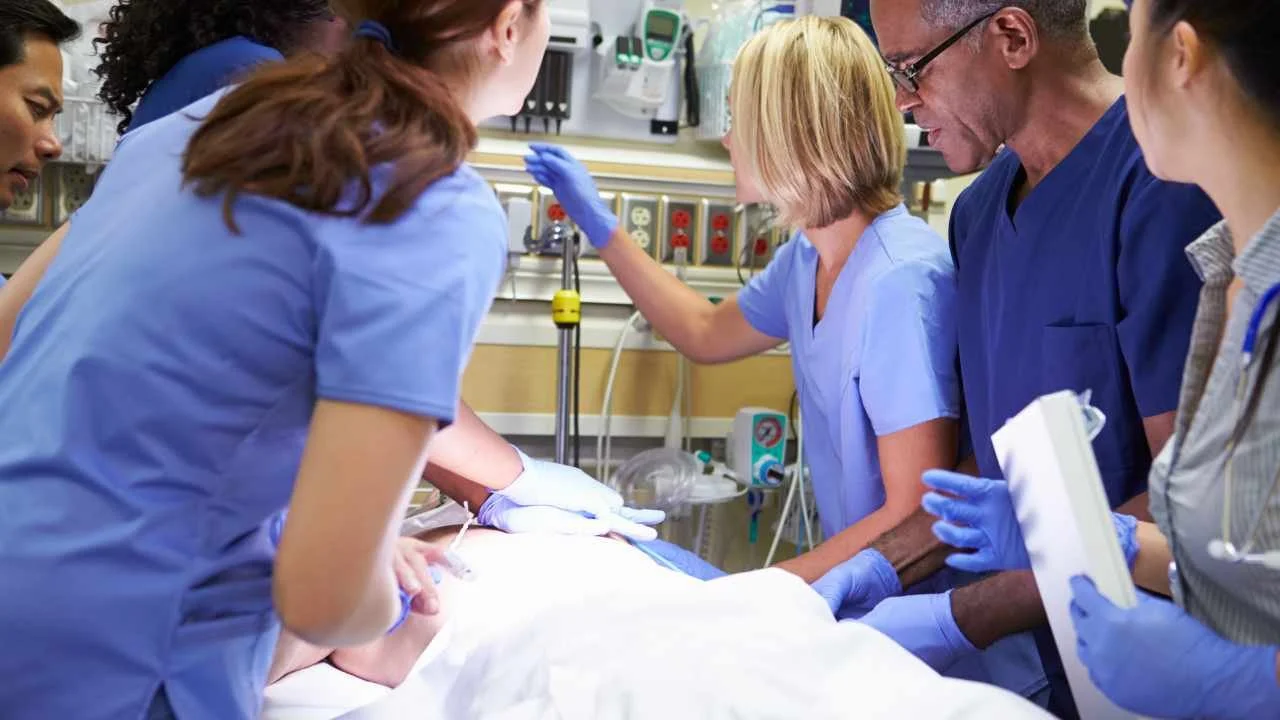 Healthcare professionals treating a patient in hospital
