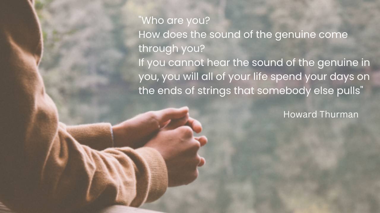 A person's hands with text of Howard Thurman quote