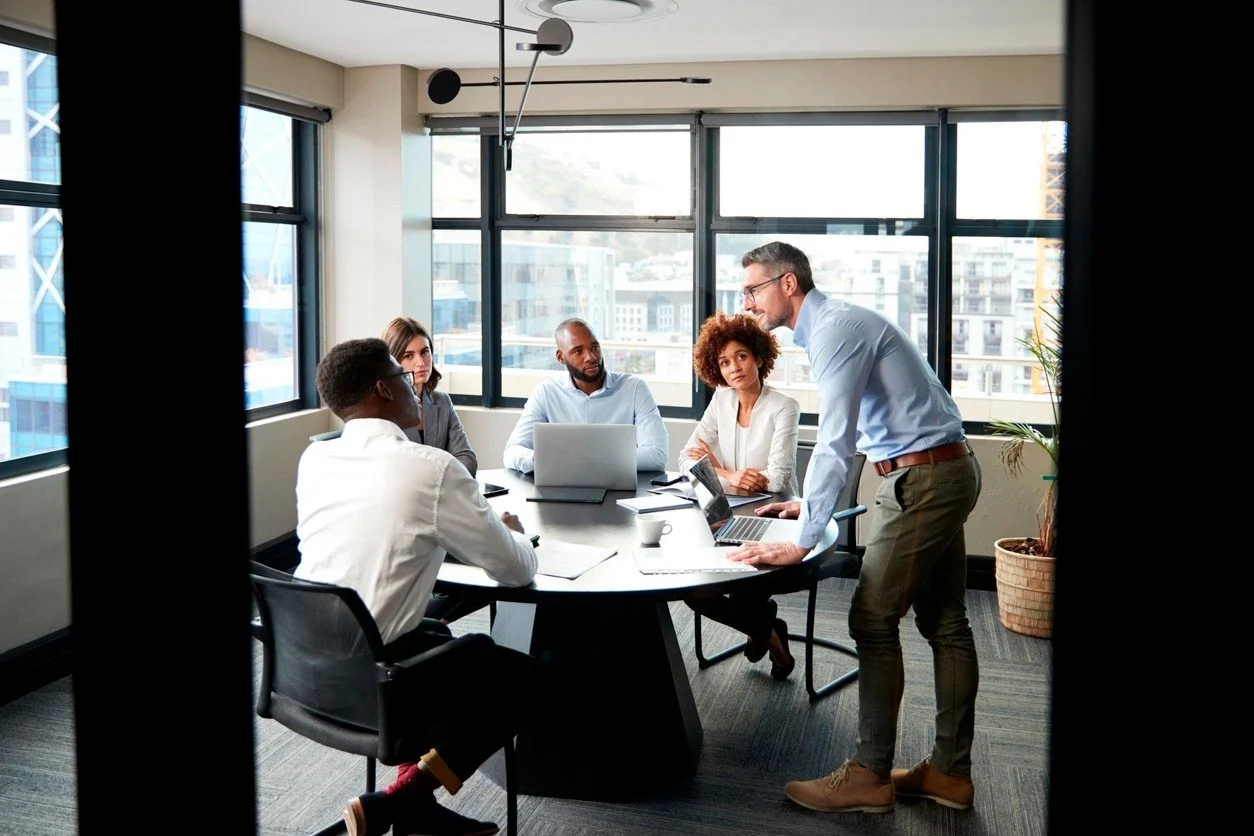 Businessman talking to team in office
