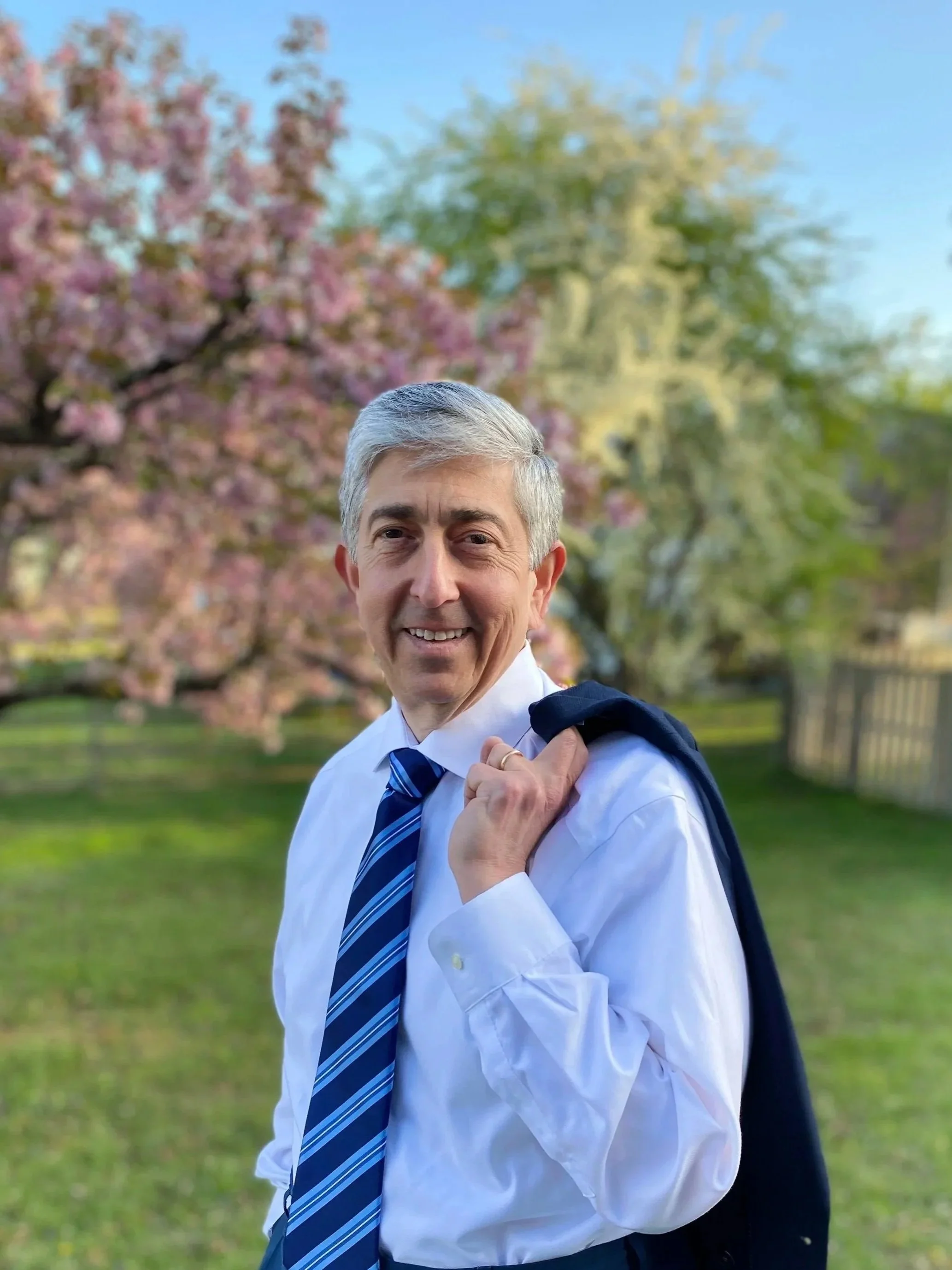 Photo of candidate Alec Stone standing in a yard