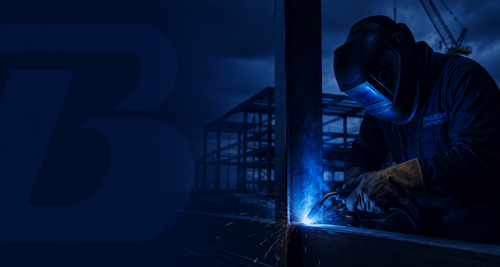 Construction worker welding at a construction site during evening or night time, with a steel framework in the background.