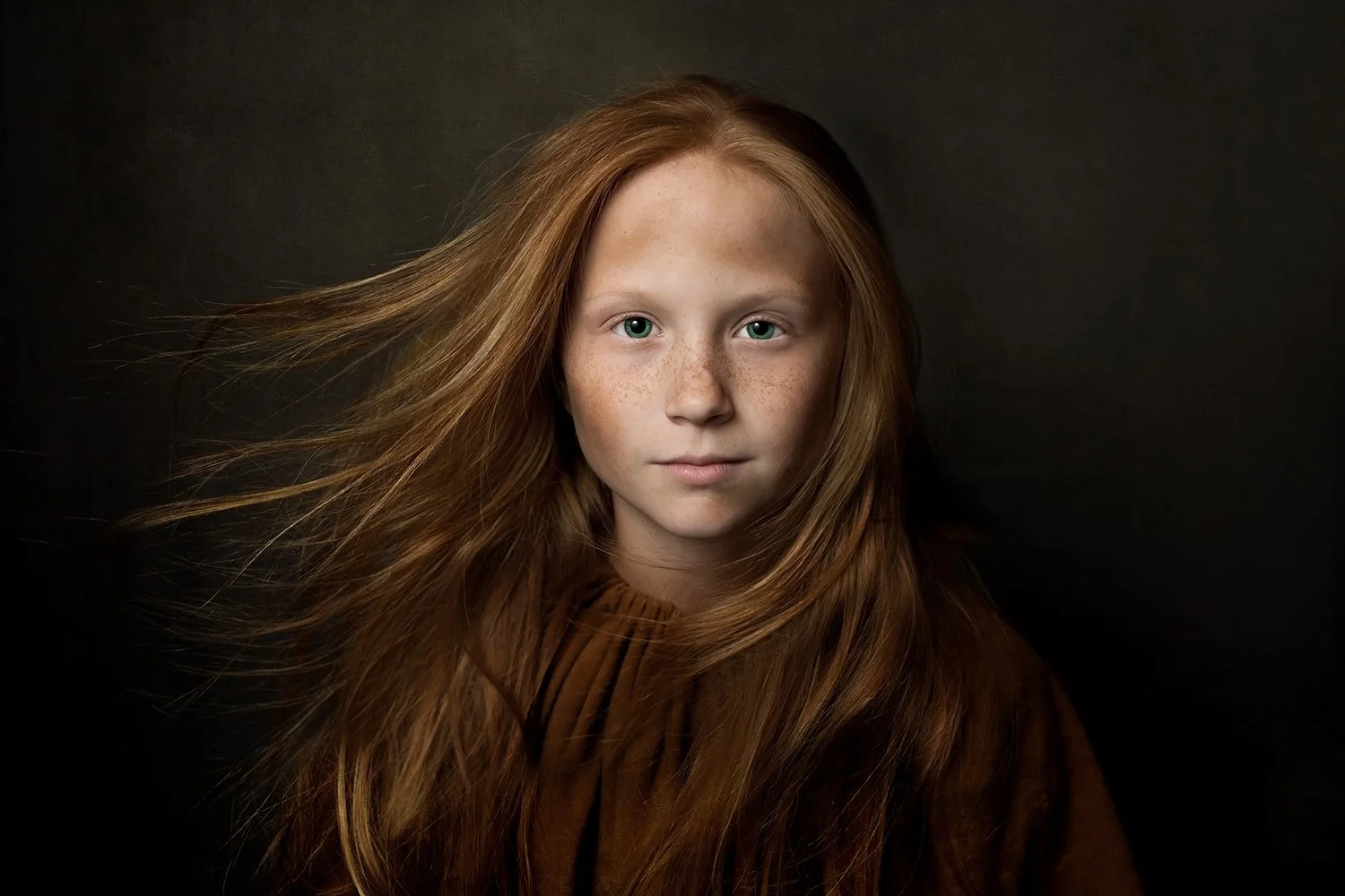 Cinematic portrait photography featuring a red-haired child with flowing hair created through Hickory Arts creative services in Hickory, NC