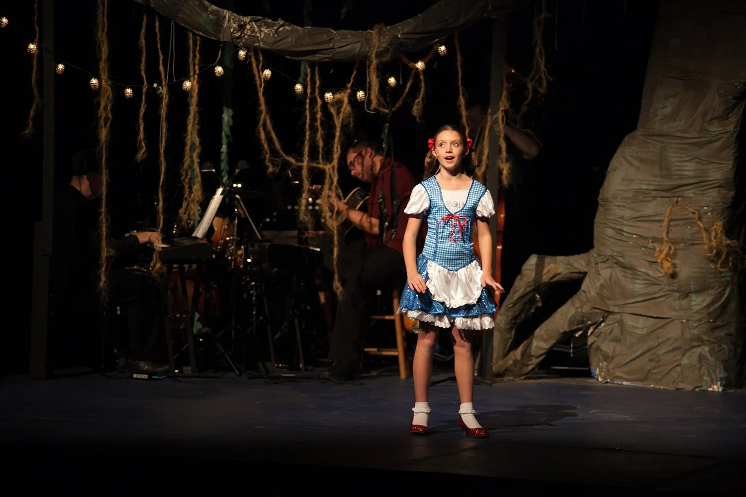 Young student performing on stage after kids voice lessons at Hickory Arts in Hickory, NC.