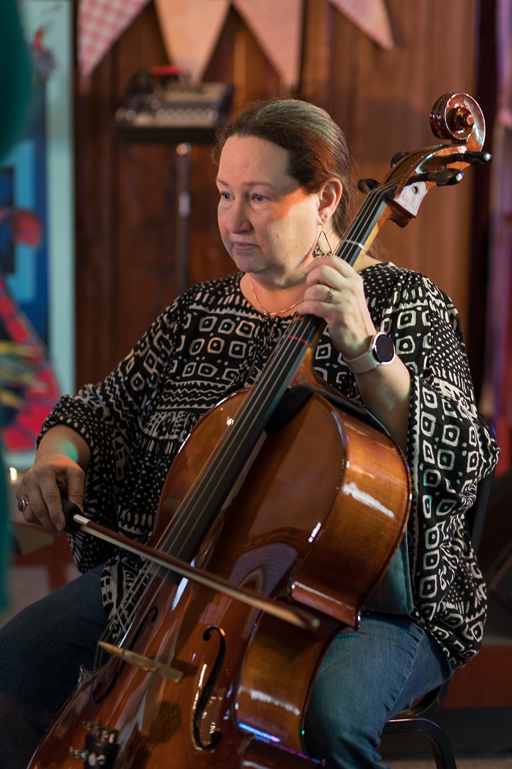 Adult student performing on cello during a Hickory Arts lesson and recital program in Hickory, North Carolina, developing technique, tone production, and artistic expression.