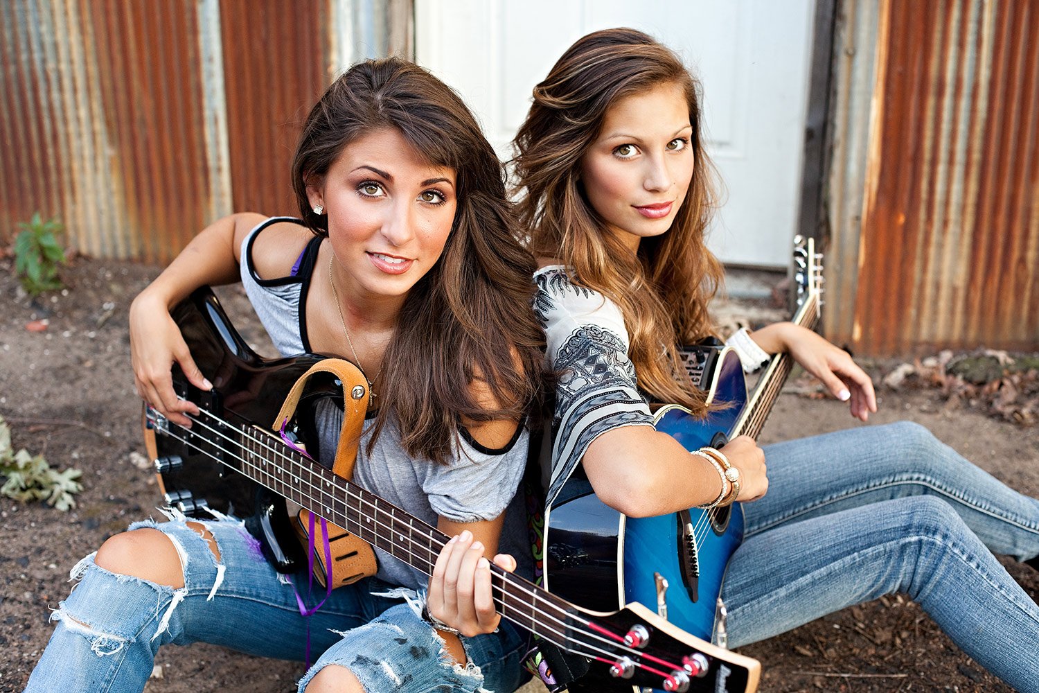 Two young musicians with acoustic guitar and bass guitar during an artist development and music mentoring session at Hickory Arts in Hickory, NC.