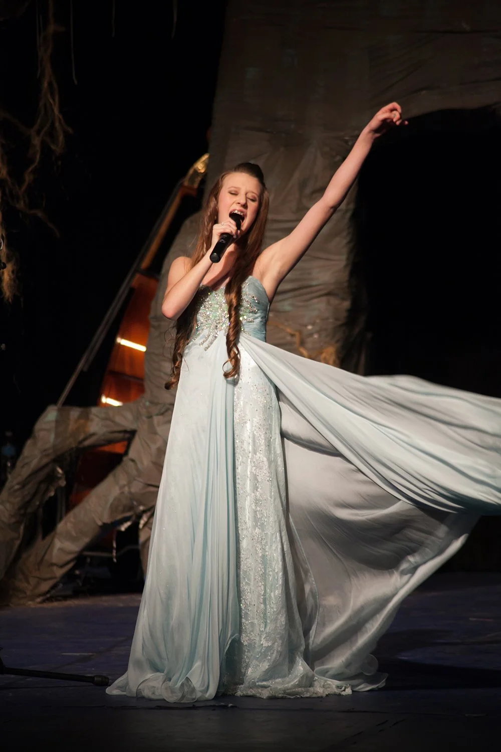 Student performing live vocals on stage during voice lessons and music training at Hickory Arts in Hickory, North Carolina.
