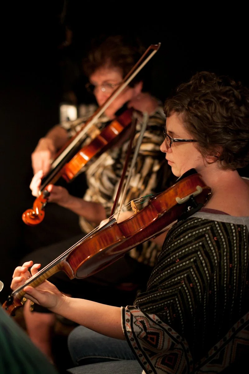 Students performing fiddle music during a Hickory Arts strings program in Hickory, North Carolina, developing rhythm, ear training, ensemble playing, and performance skills.