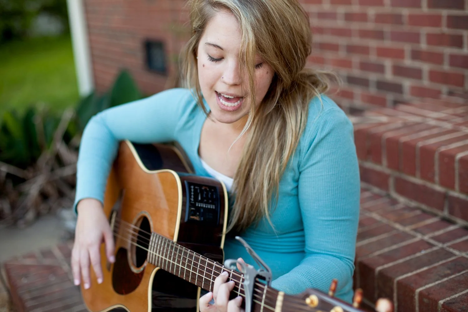 Student learning to sing and play guitar during a self-accompaniment lesson at Hickory Arts in Hickory, North Carolina.