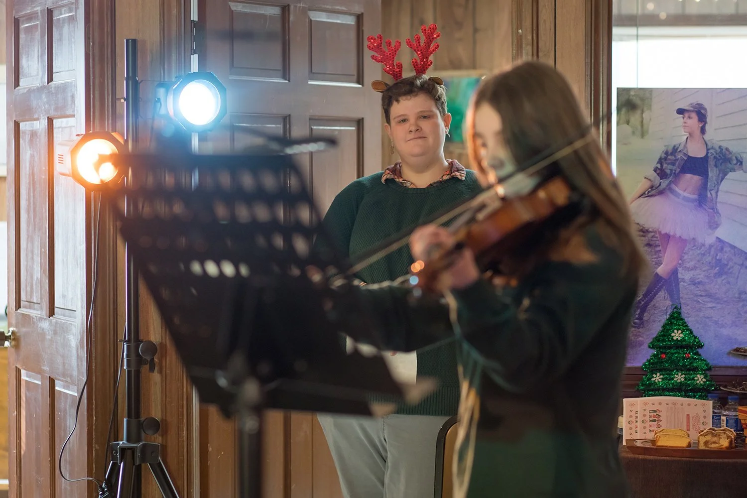 Andrea Jove watching a violin student perform during a Hickory Arts strings recital in Hickory NC.
