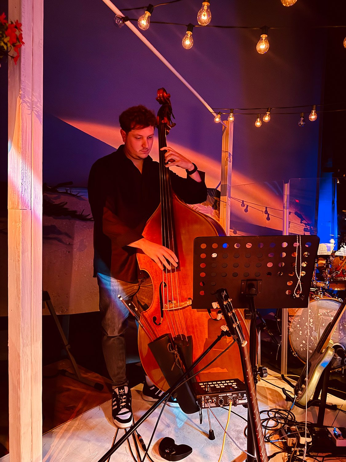Jackson Sigmon performing upright bass during a live jazz and contemporary music performance at Hickory Arts.