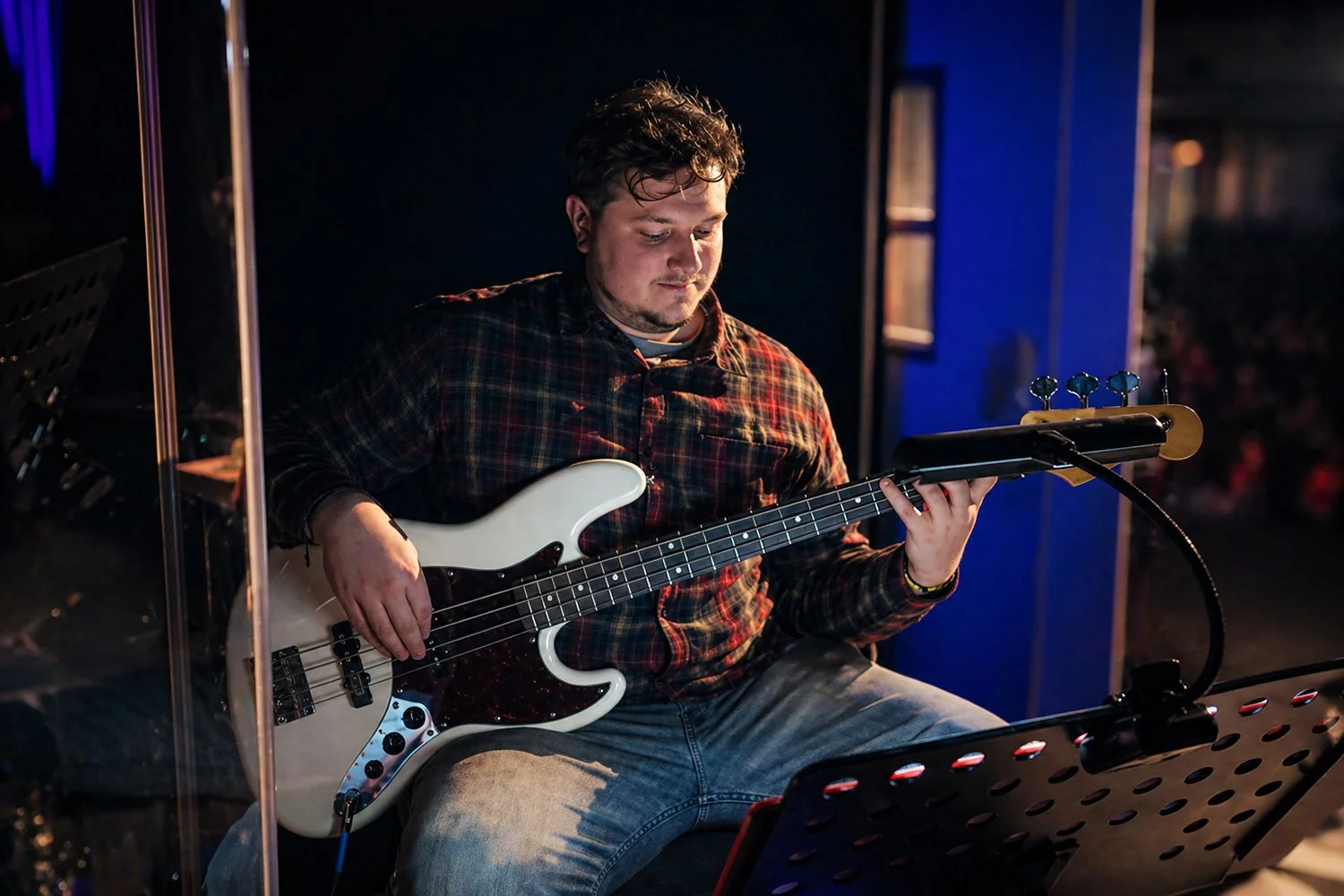Jackson Sigmon performing bass guitar during a live music production and student performance session at Hickory Arts.