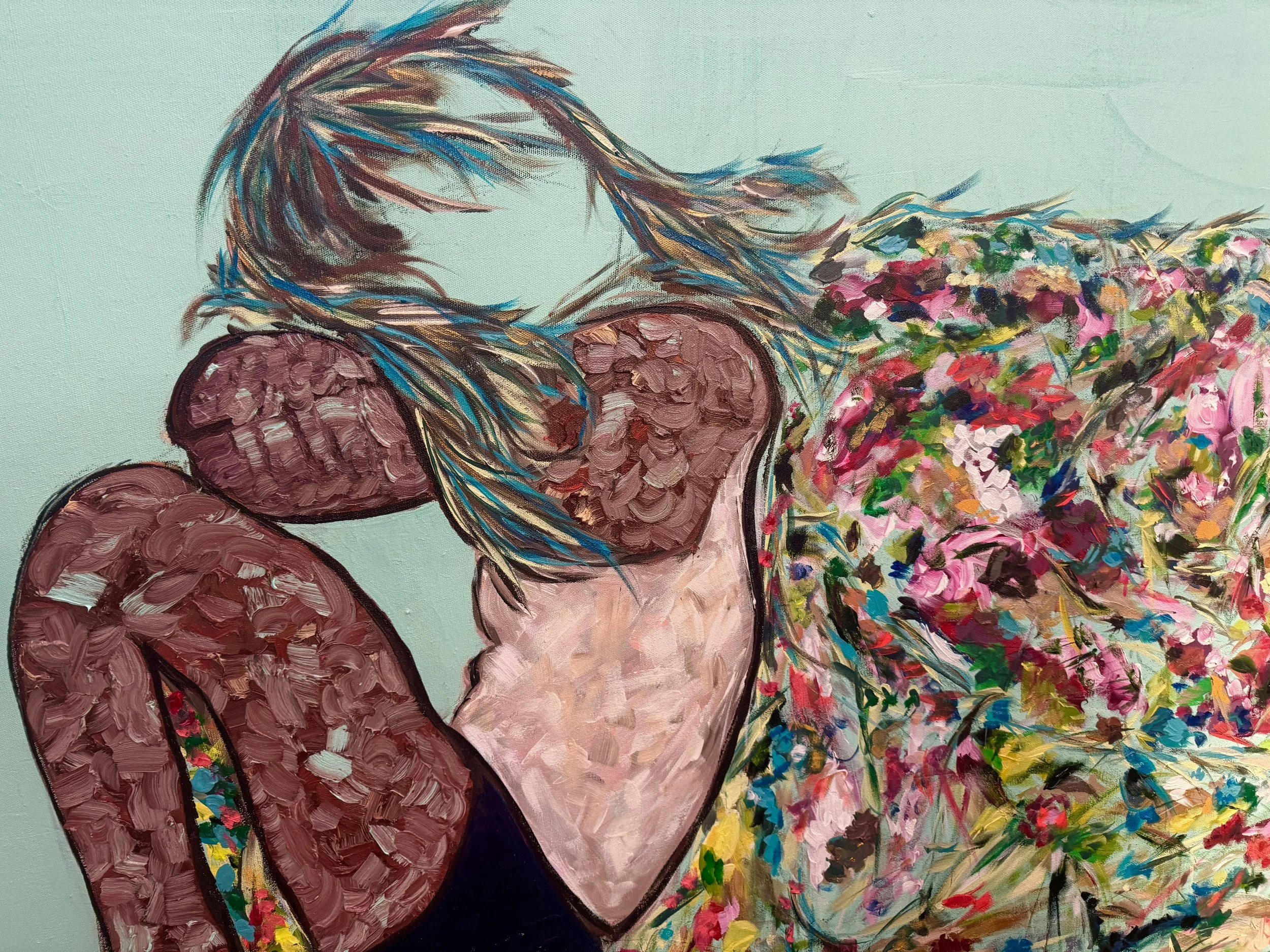 An abstract painting of a woman with long, flowing hair, sitting with her head bowed and her arms crossed over her knees. She wears a floral dress with vibrant and colorful brushstrokes.