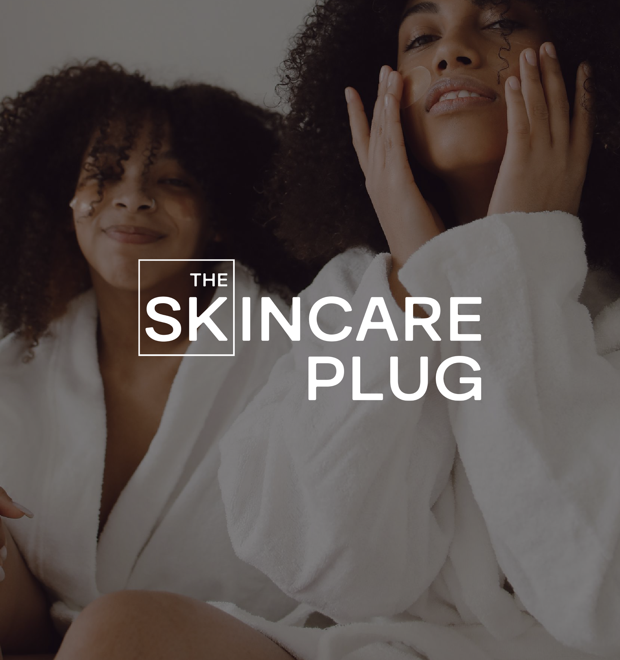 Close-up of a woman with curly hair applying skincare, wearing a white towel, with text 'The Skincare Plug' overlaid.
