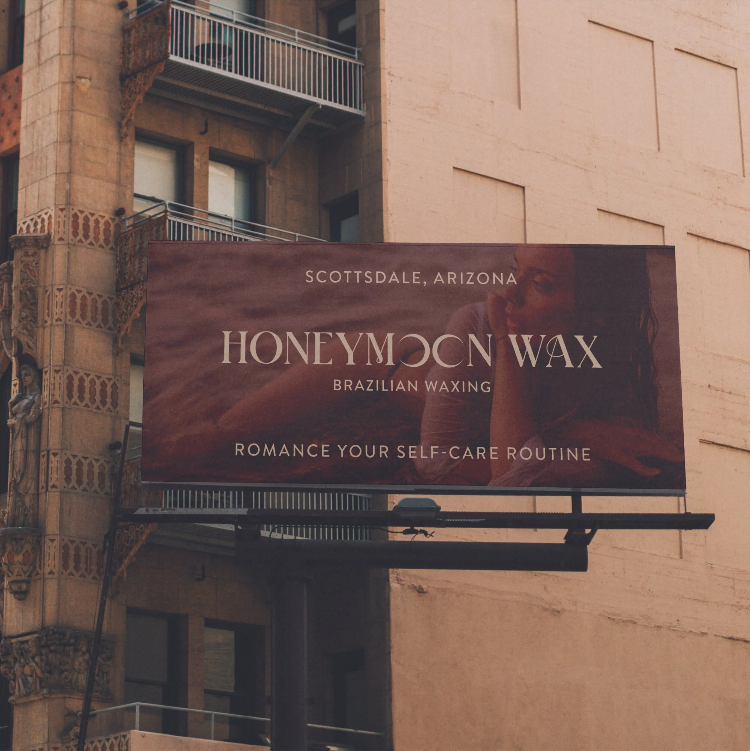Building with balconies, some with air conditioning units, and a sign that says 'Scottsdale, Arizona' along with the words 'Honeywax Brazilian Waxing'.