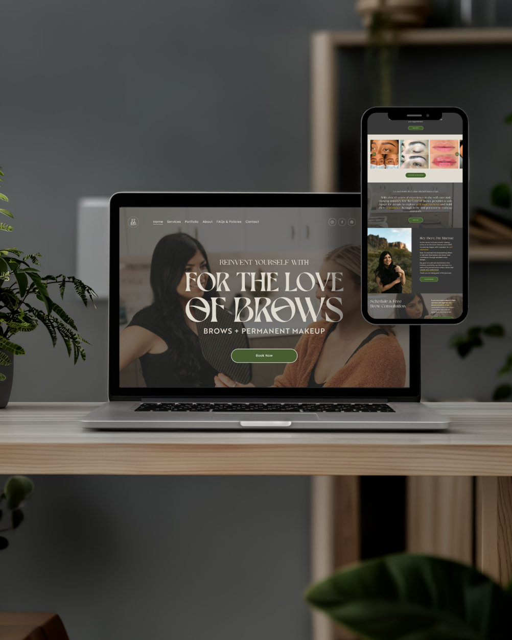 Laptop and smartphone displaying a beauty salon website focused on brows and permanent makeup, on a wooden desk with green plants around.