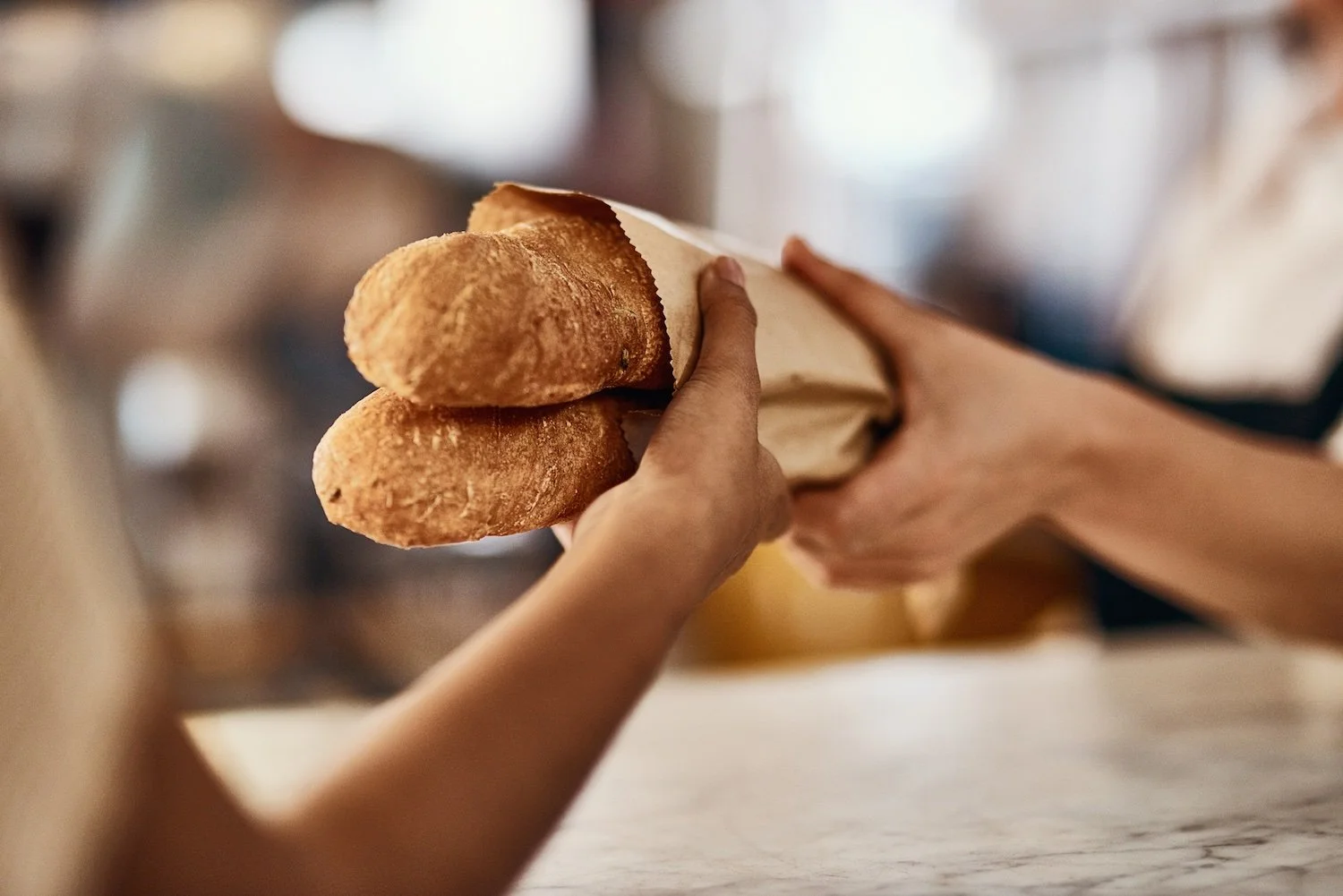 people exchanging two loaves of bread