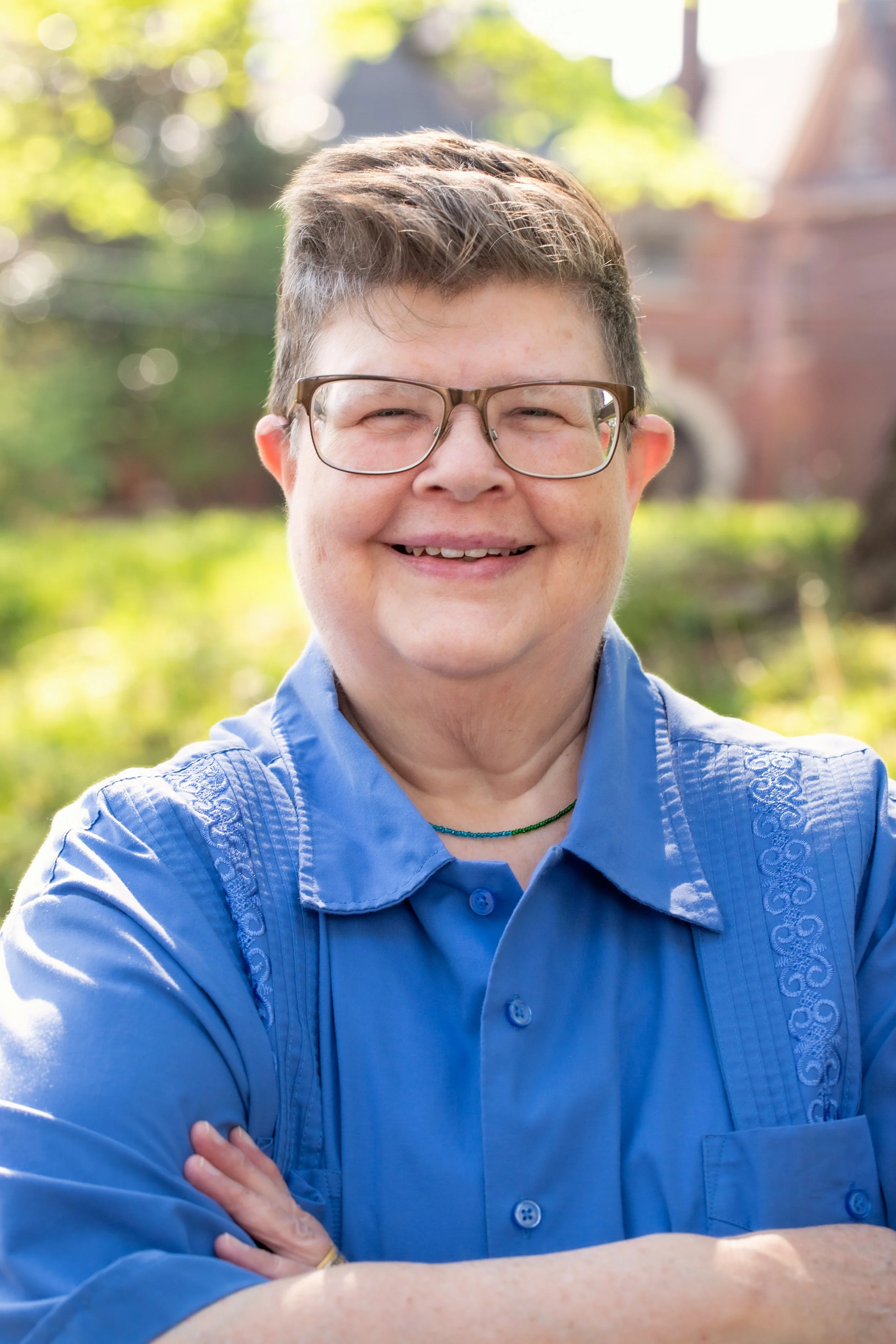 Kathy, smiling, in a blue shirt.
