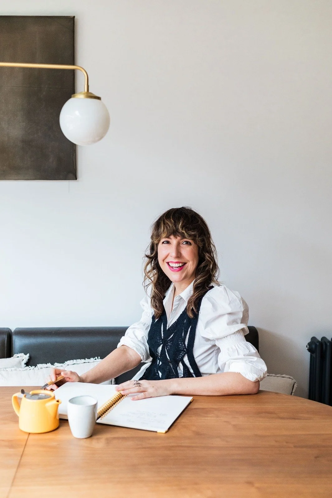 Becs Pearson, copywriter, sitting at desk writing
