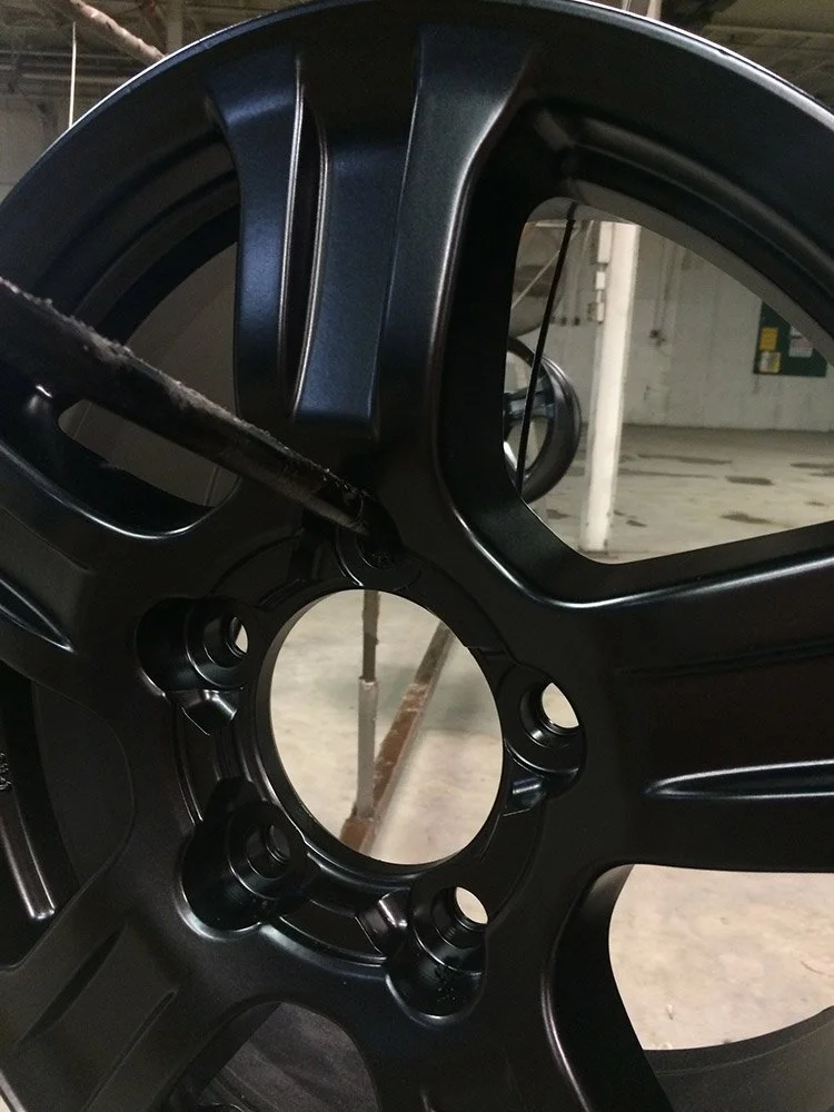 Black powdered coated car rim.