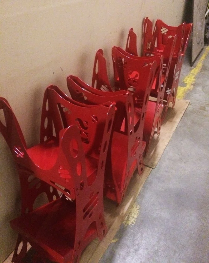 A row of red metal powder coated components.