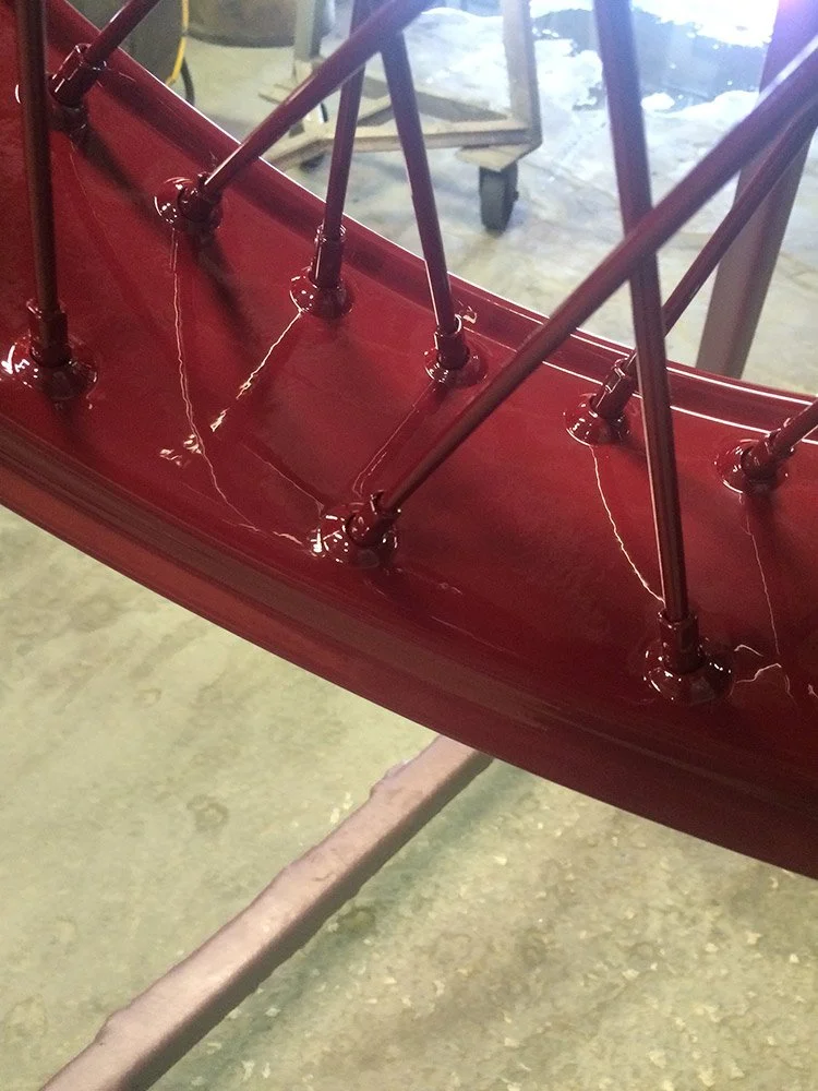 Close-up of a red metal powder coating.