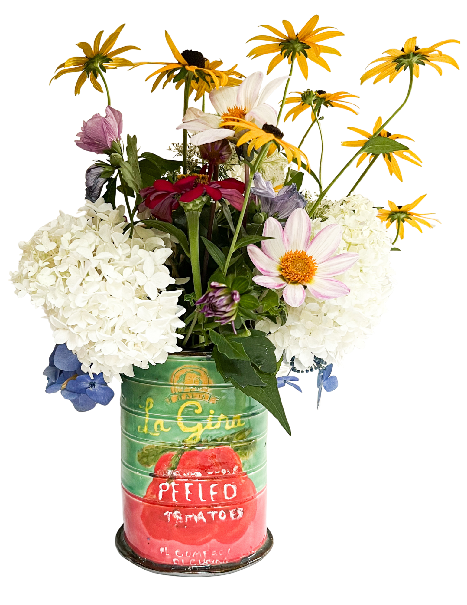A bouquet of mixed flowers, including white hydrangeas, pink and white cosmos, purple and pink zinnias, and yellow daisies, arranged in a hand painted ceramic tomato can labeled 'La Gina peeled Tomatoes'.