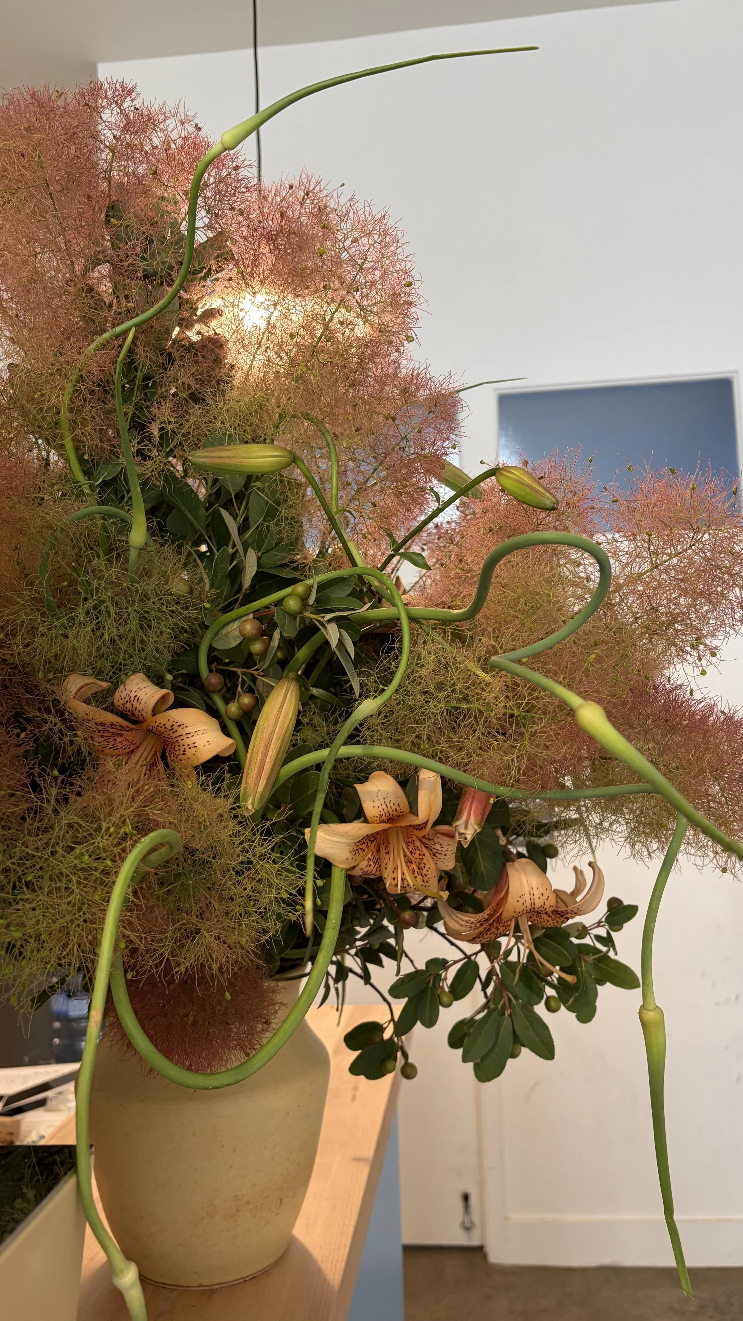 Smoke bush, tiger lilies and garlic scape arrangement next for Third Wheel Coffee in San Francisco.