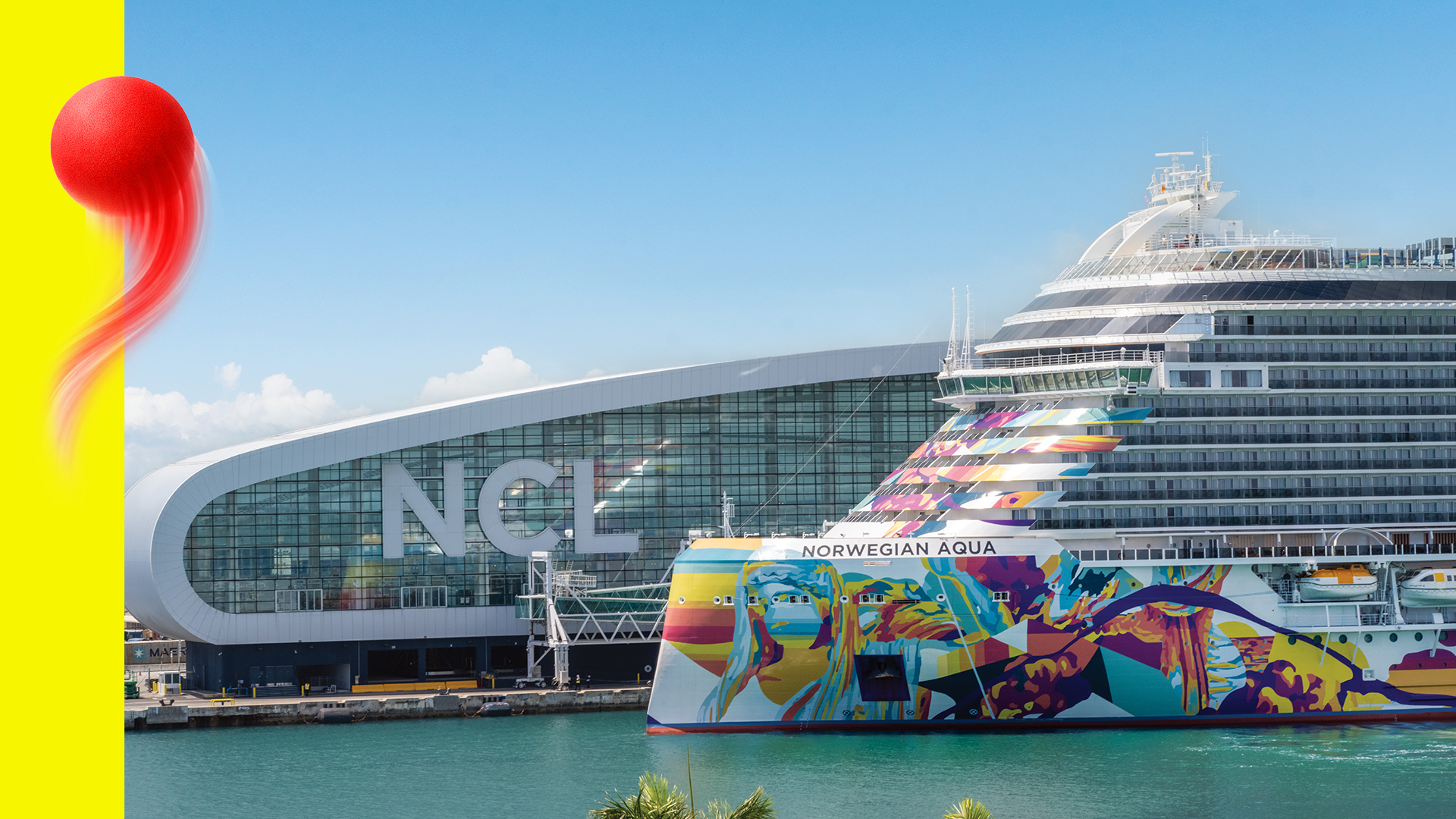 Cruise ship named Norwegian Aqua docked at a modern port terminal with the letters NCL on the building, under a blue sky with some clouds.