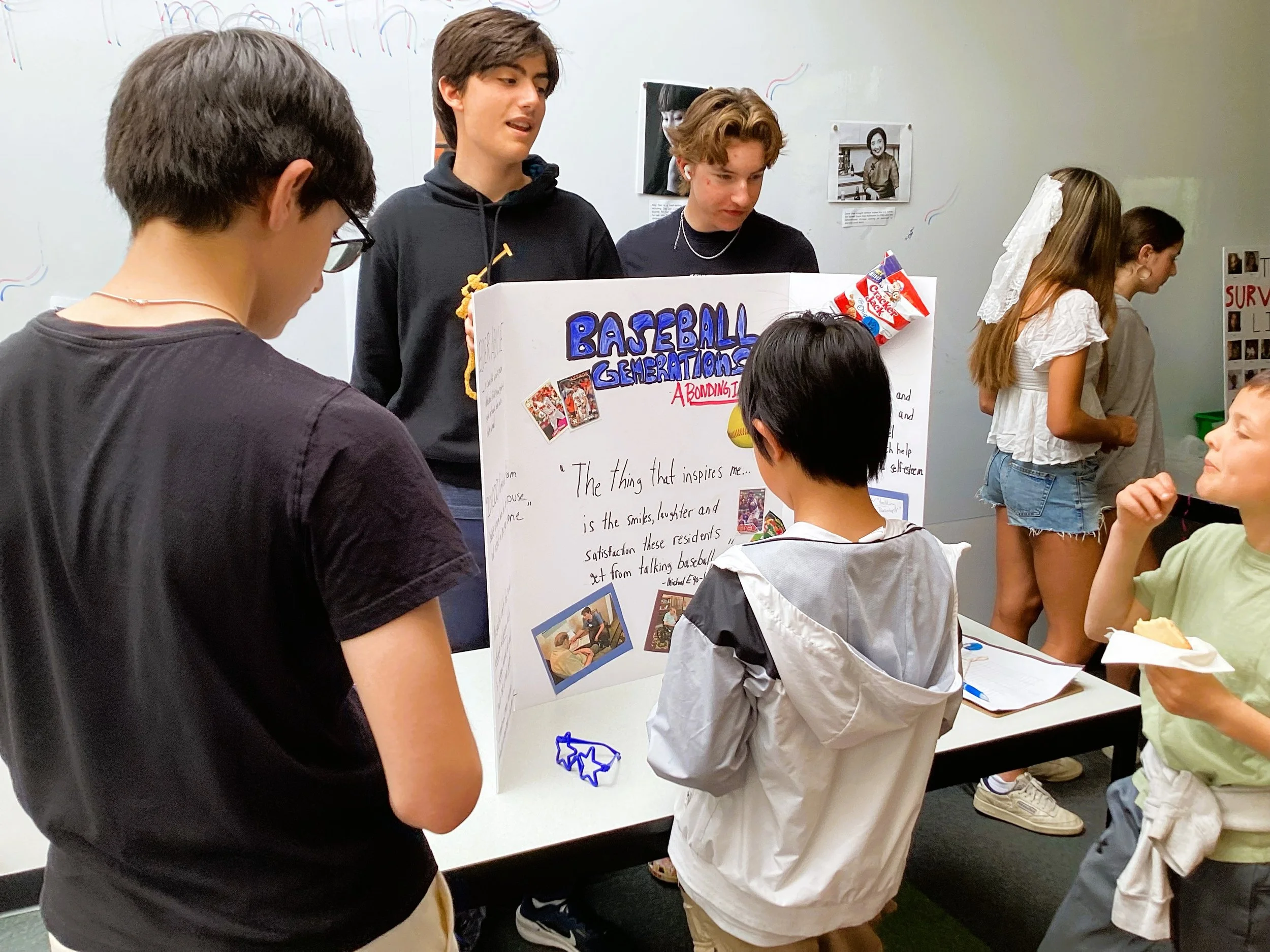 Group of students presenting a science project titled 'Baseball Generations' at a school fair.