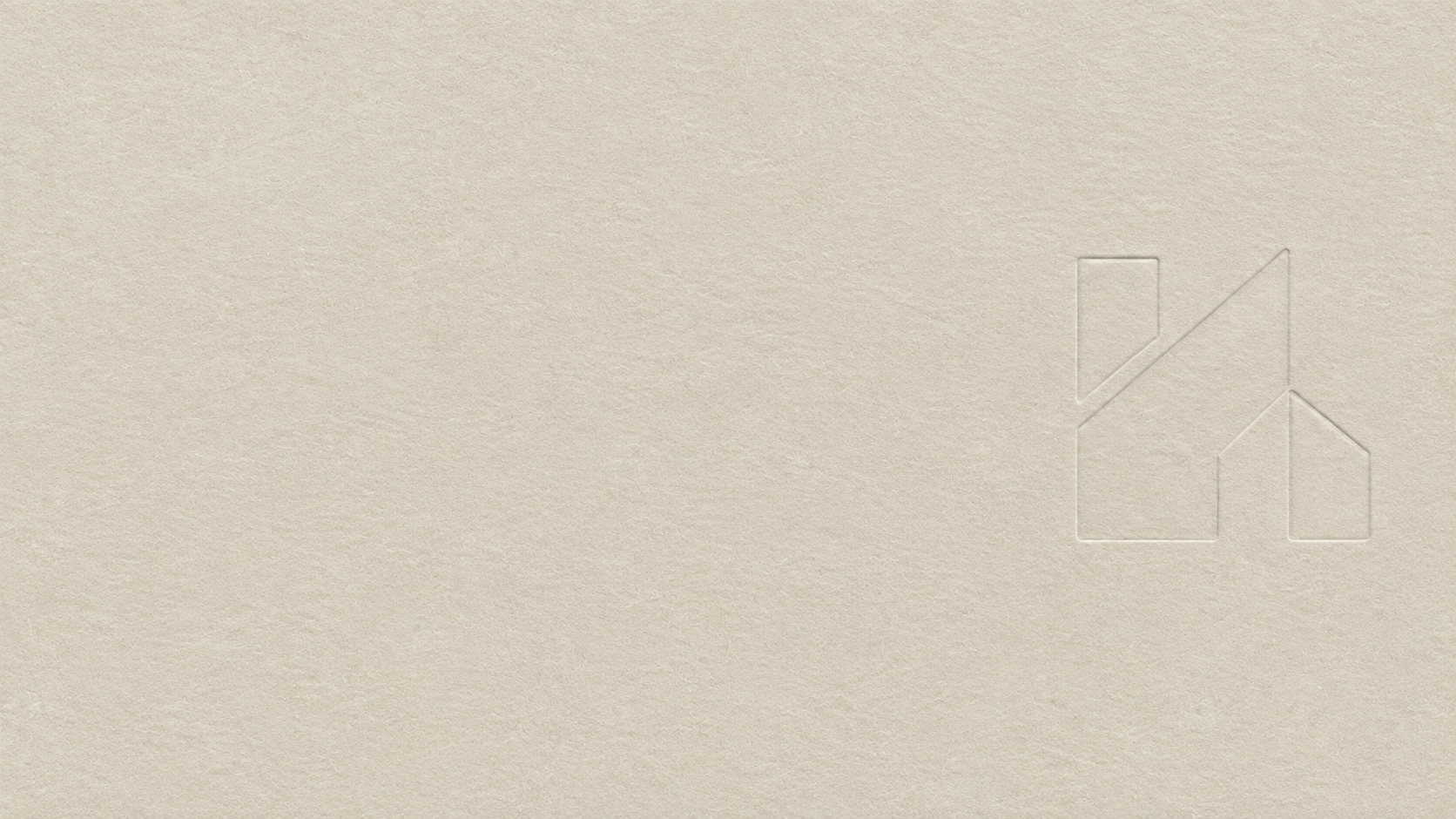 Close-up of a beige textured surface with an embossed geometric house and arrow logo in the bottom right corner.