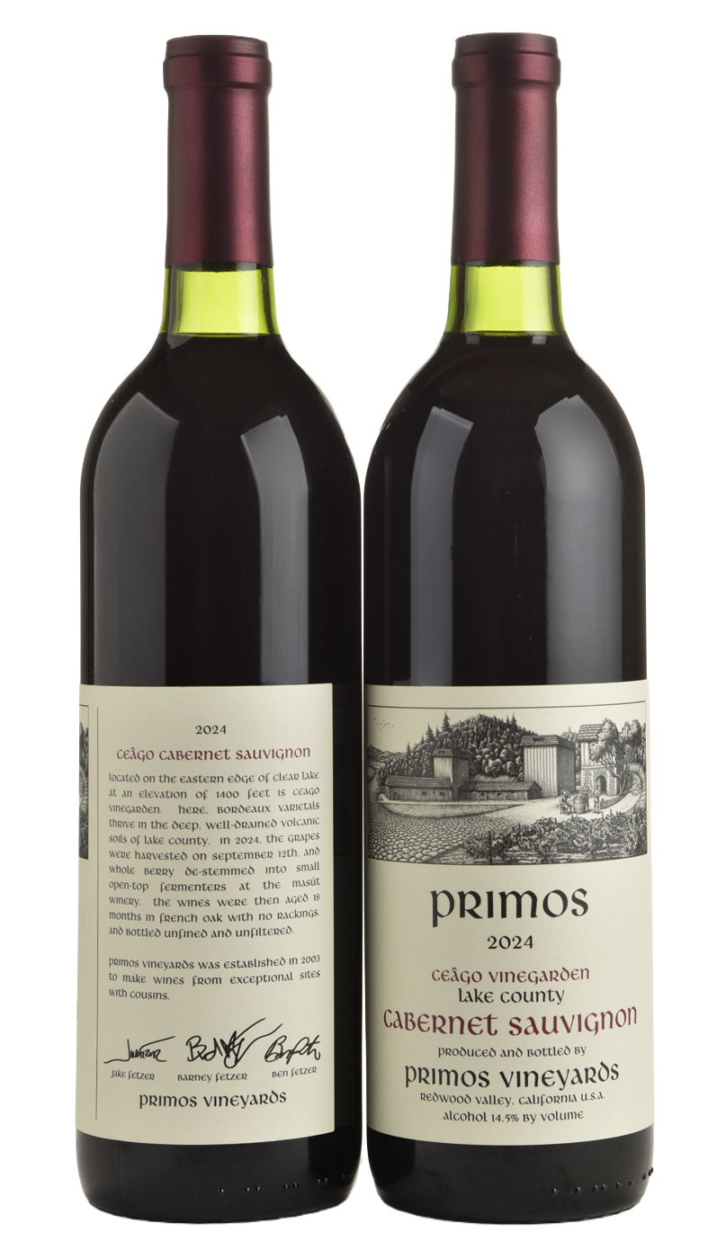 Two bottles of 2024 Cabernet Sauvignon wine from Primos Vineyards in Lake County, California, with detailed labels describing the vineyard and wine.
