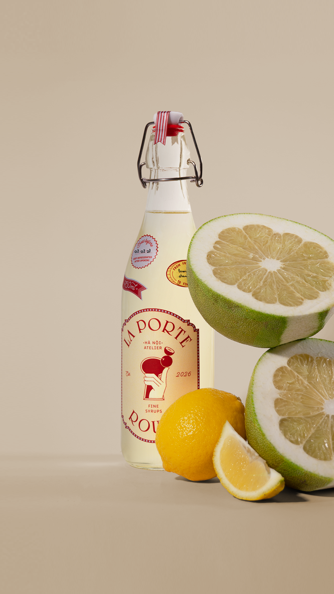 A bottle labeled 'La Porte Rouge' with a red and white label, surrounded by sliced lemons and two halves of a grapefruit on a light background.