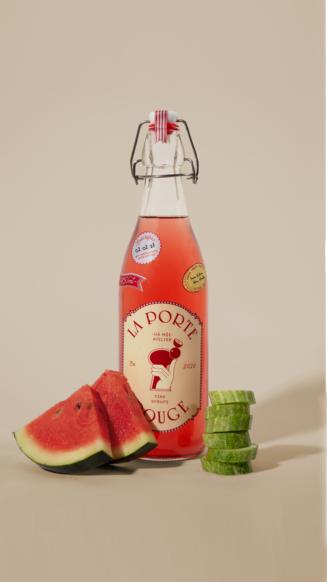 A glass bottle labeled 'La Porte Rouge' with a red and beige design, surrounded by slices of watermelon and cucumber on a beige background.